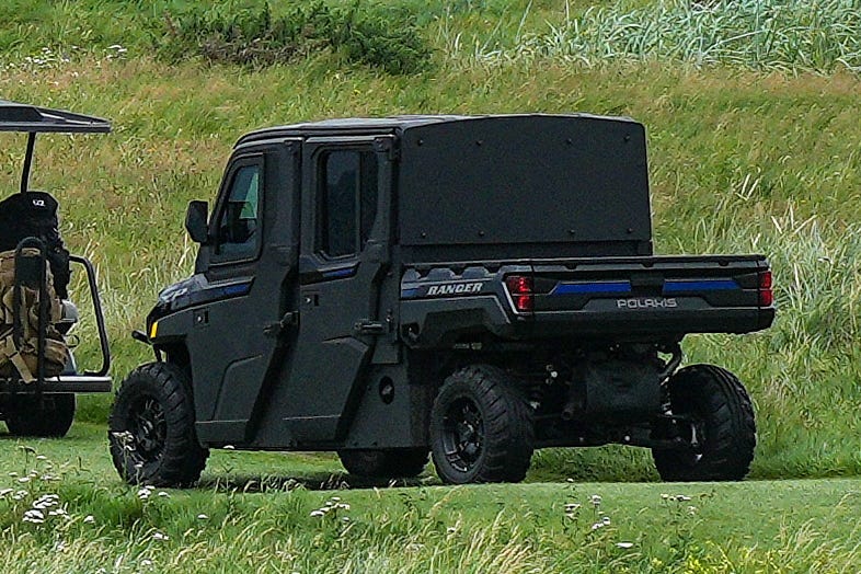 A line of golf carts follow Donald Trump at Trump Turnberry in Scotland.