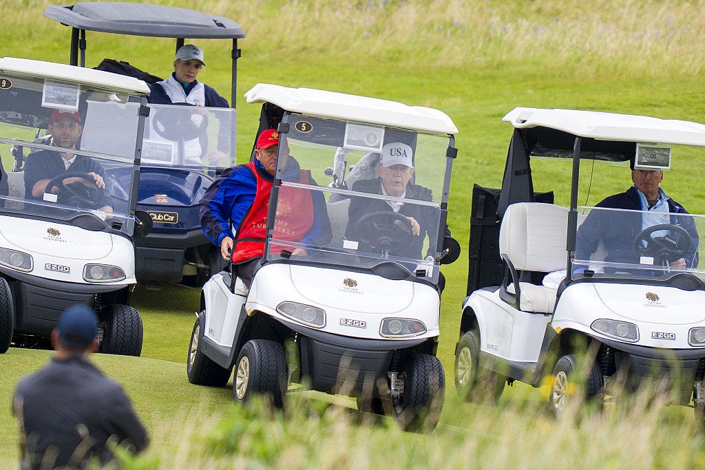 Donald Trump drives a golf cart in Scotland.
