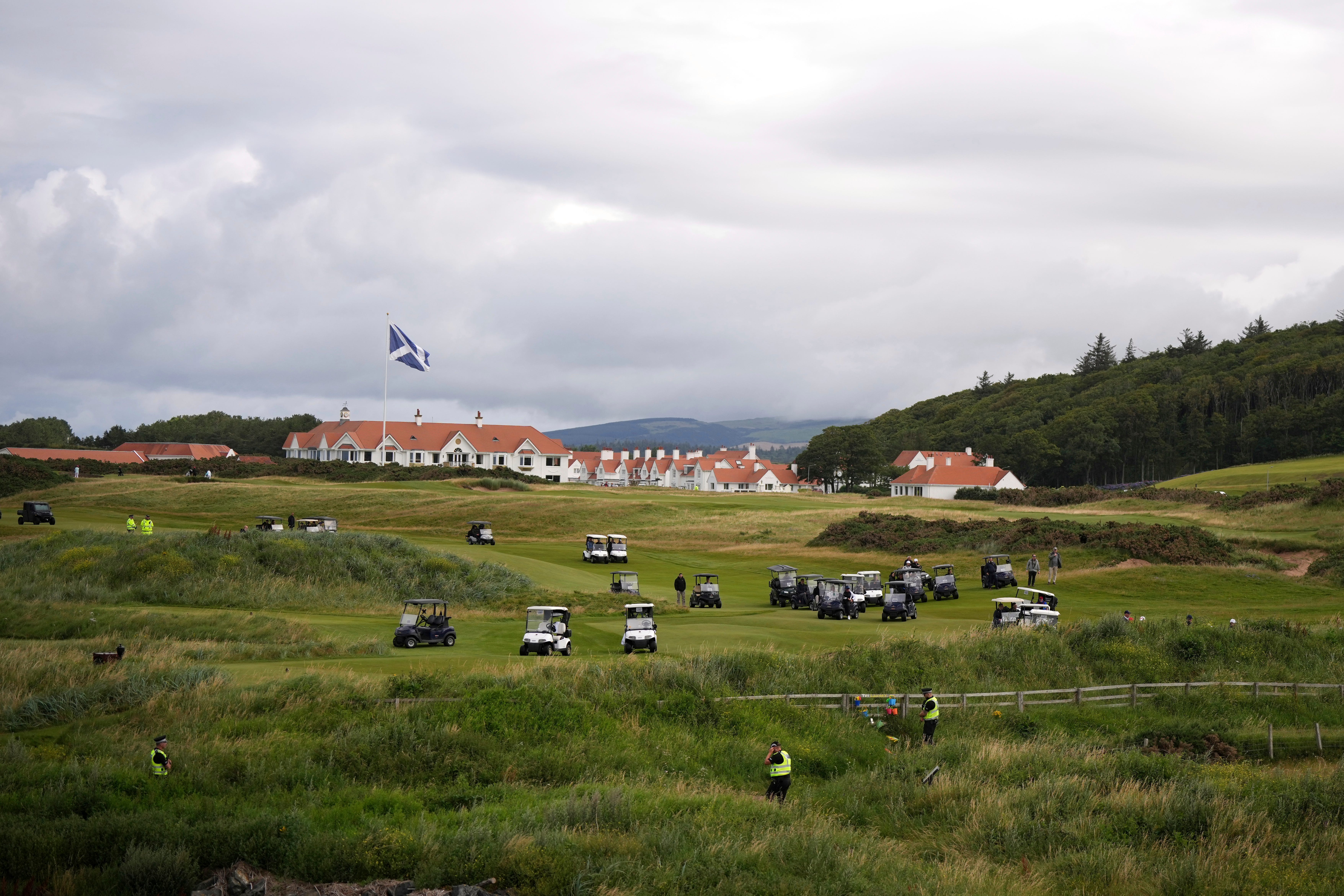 Golf carts surround President Donald Trump at Trump Turnberry.