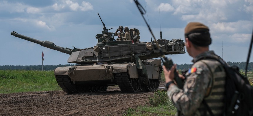 A Romanian soldier relays ground attack operations over radio during a joint combined arms live-fire exercise at the Bemowo Piskie Training Area, Poland, July 16, 2025.