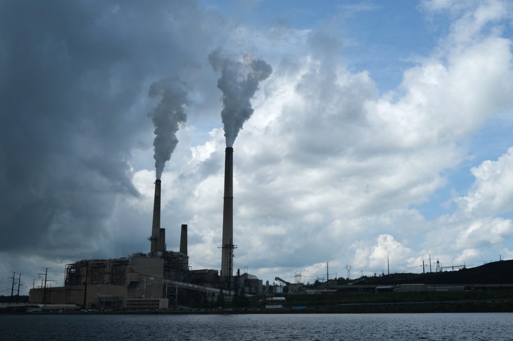 Coal-fired power plant emitting smoke.