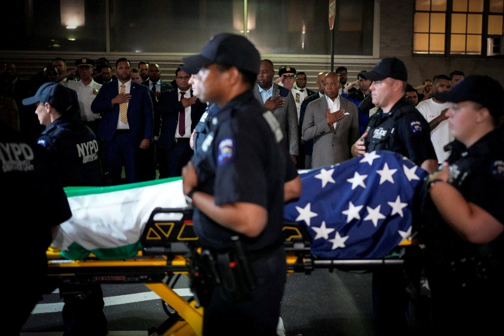 New York Mayor Eric Adams and NYPD officers at the dignified transfer of slain NYPD Officer Didarul Islam.