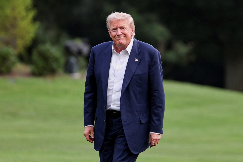 President Trump smiling at the White House.