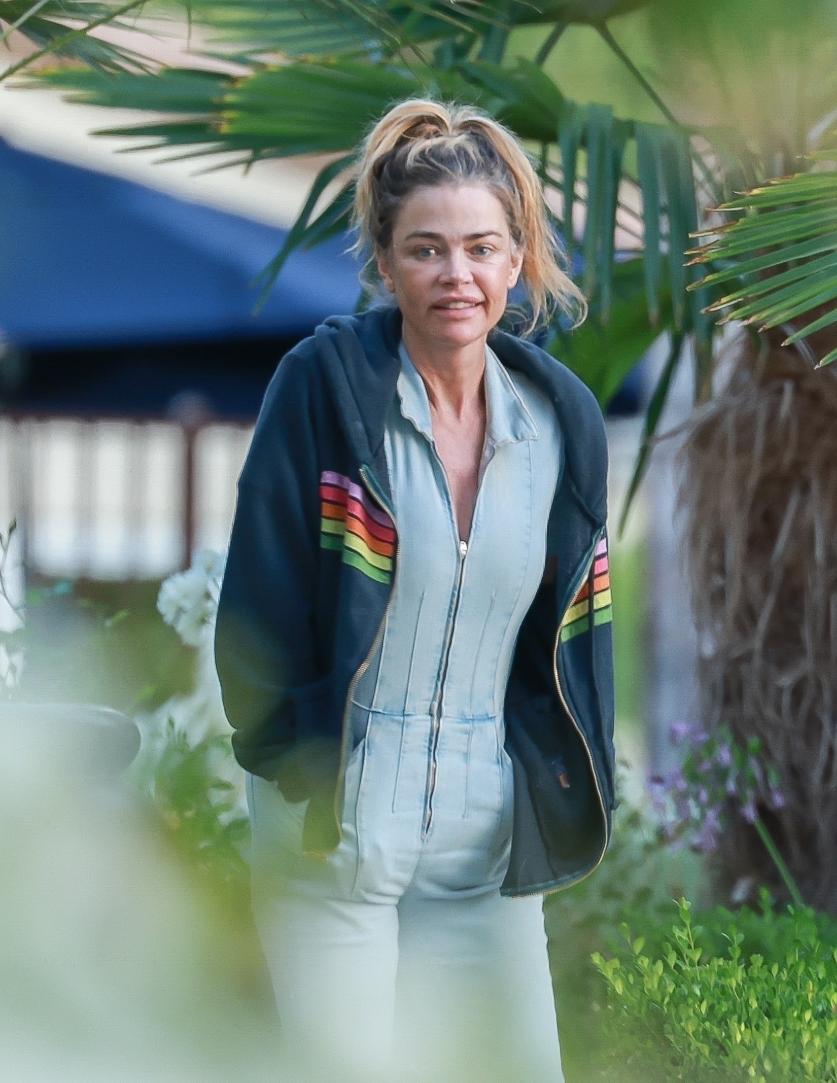 Denise Richards outdoors in a jacket. 