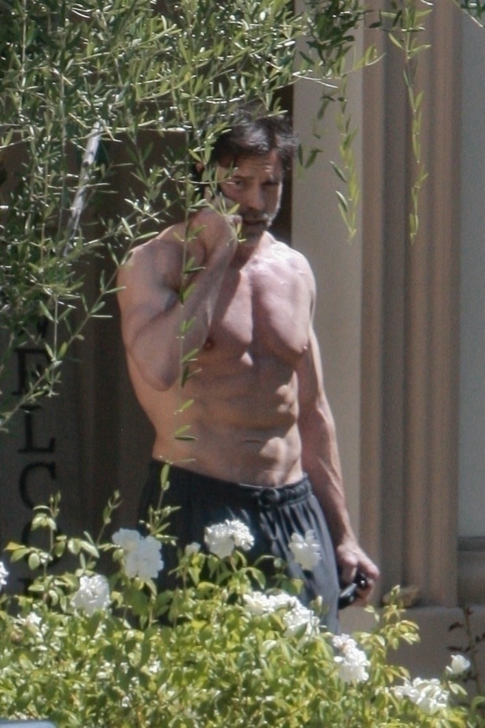 Aaron Phypers shirtless on a phone call. 