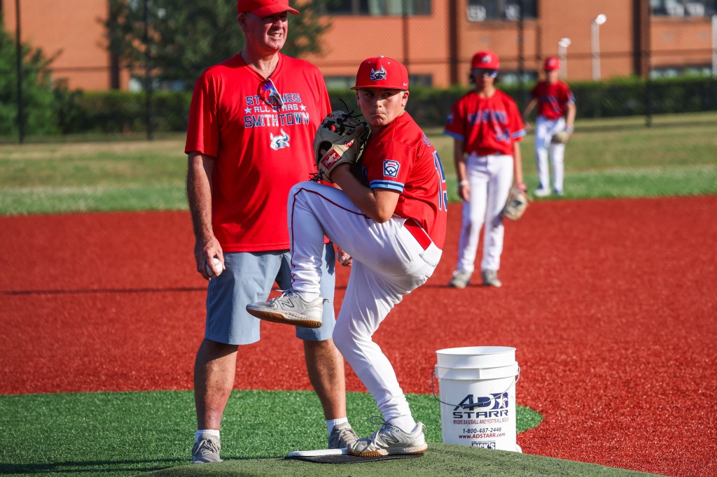 Little league baseball player pitching during practice.