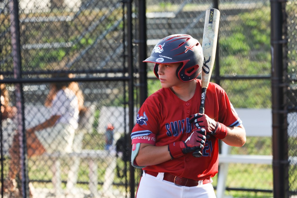 A young baseball player at bat during practice.