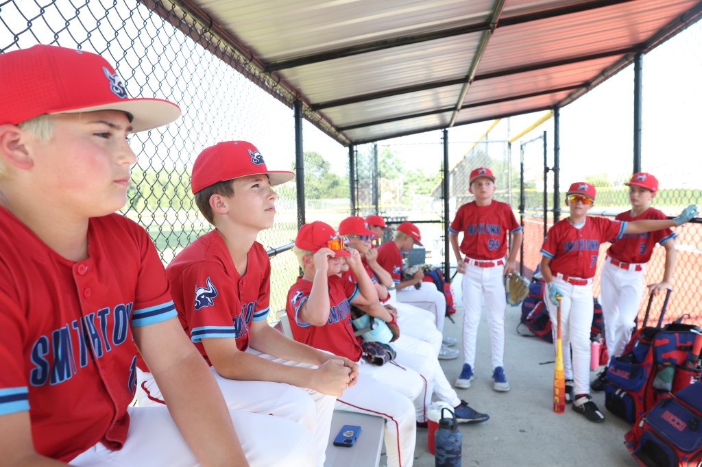 Little league baseball team in dugout.