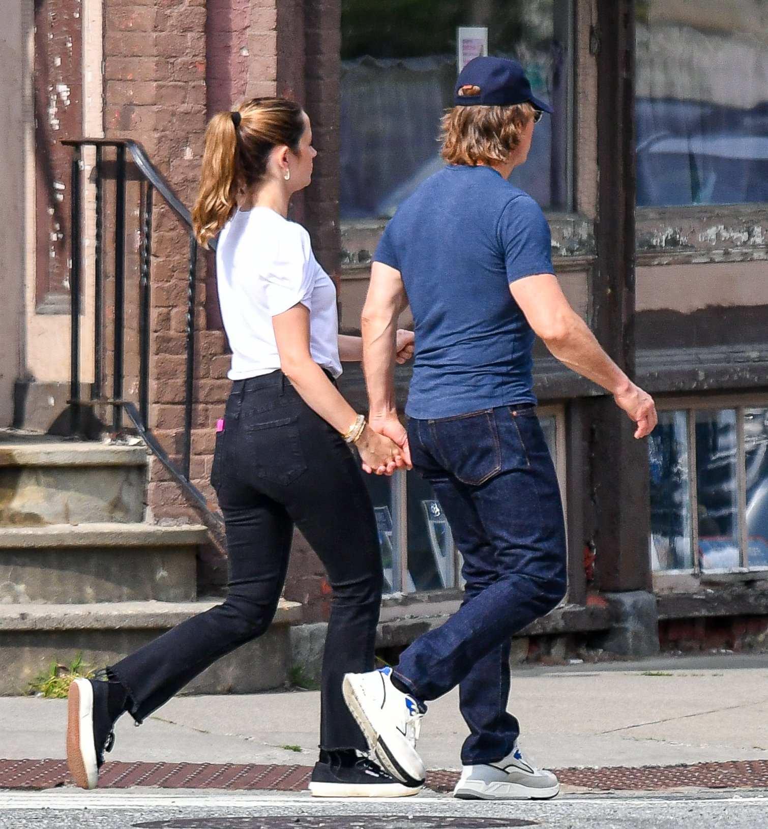 Tom Cruise and Ana de Armas hold hands on a walk. 