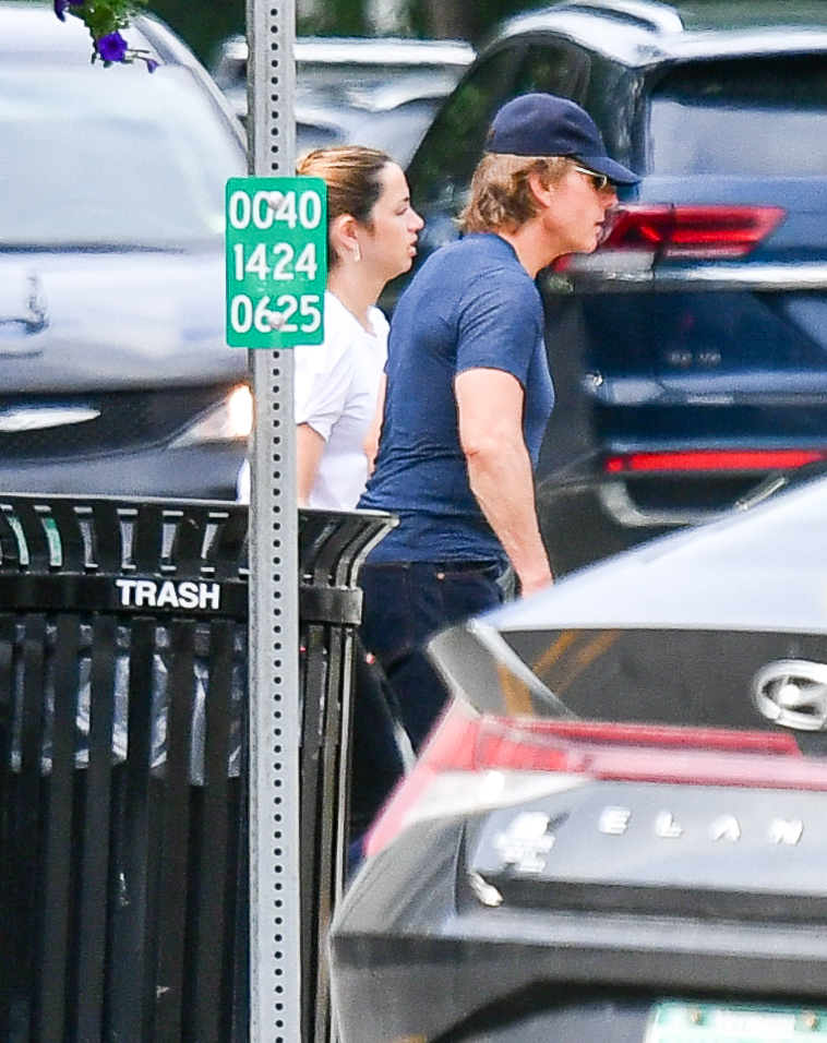 Tom Cruise and Ana de Armas walk outdoors.