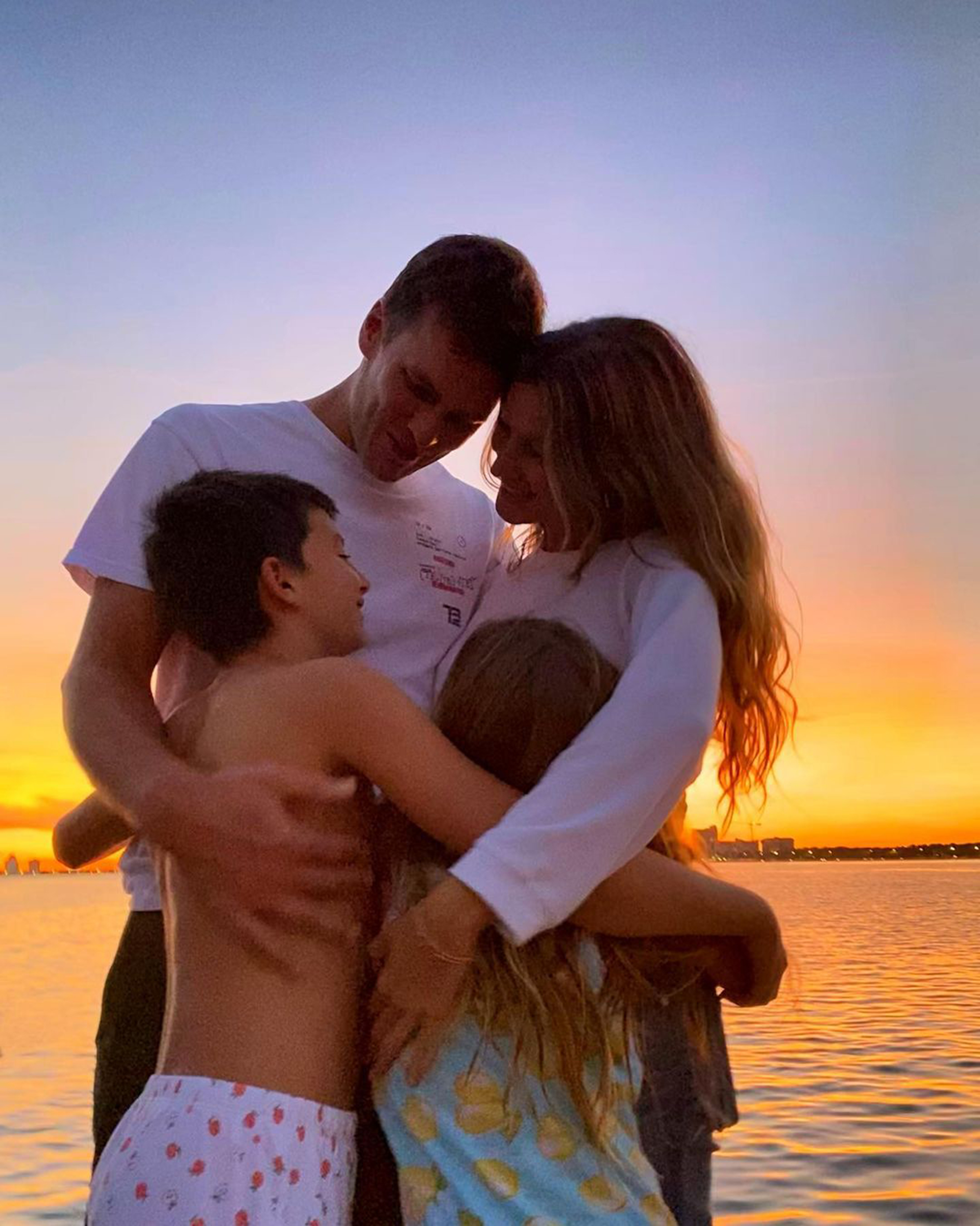 Tom Brady, Gisele Bünchen, and their two kids embrace. 