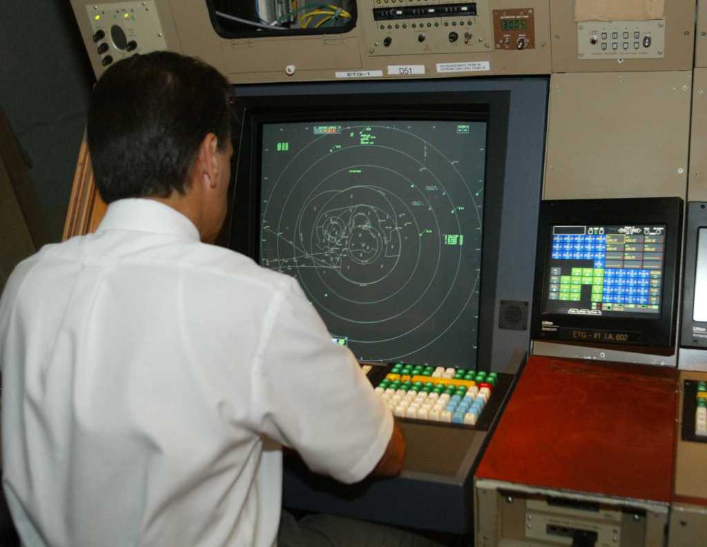 Air traffic controller at a radar console.