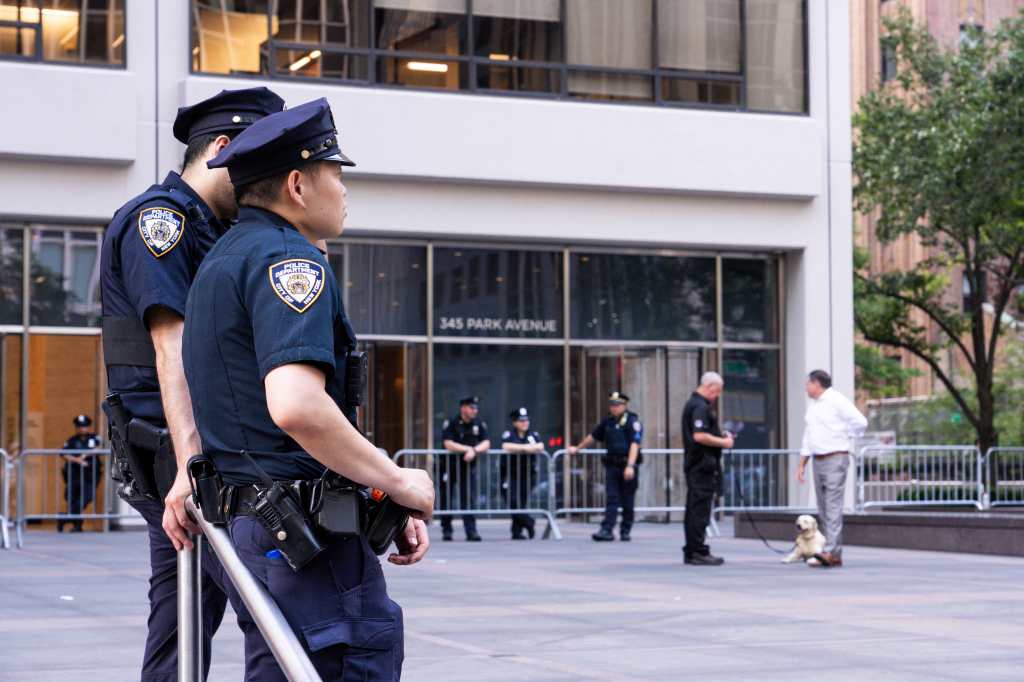 NYPD officers guarding 345 Park Avenue after a Midtown shooting.