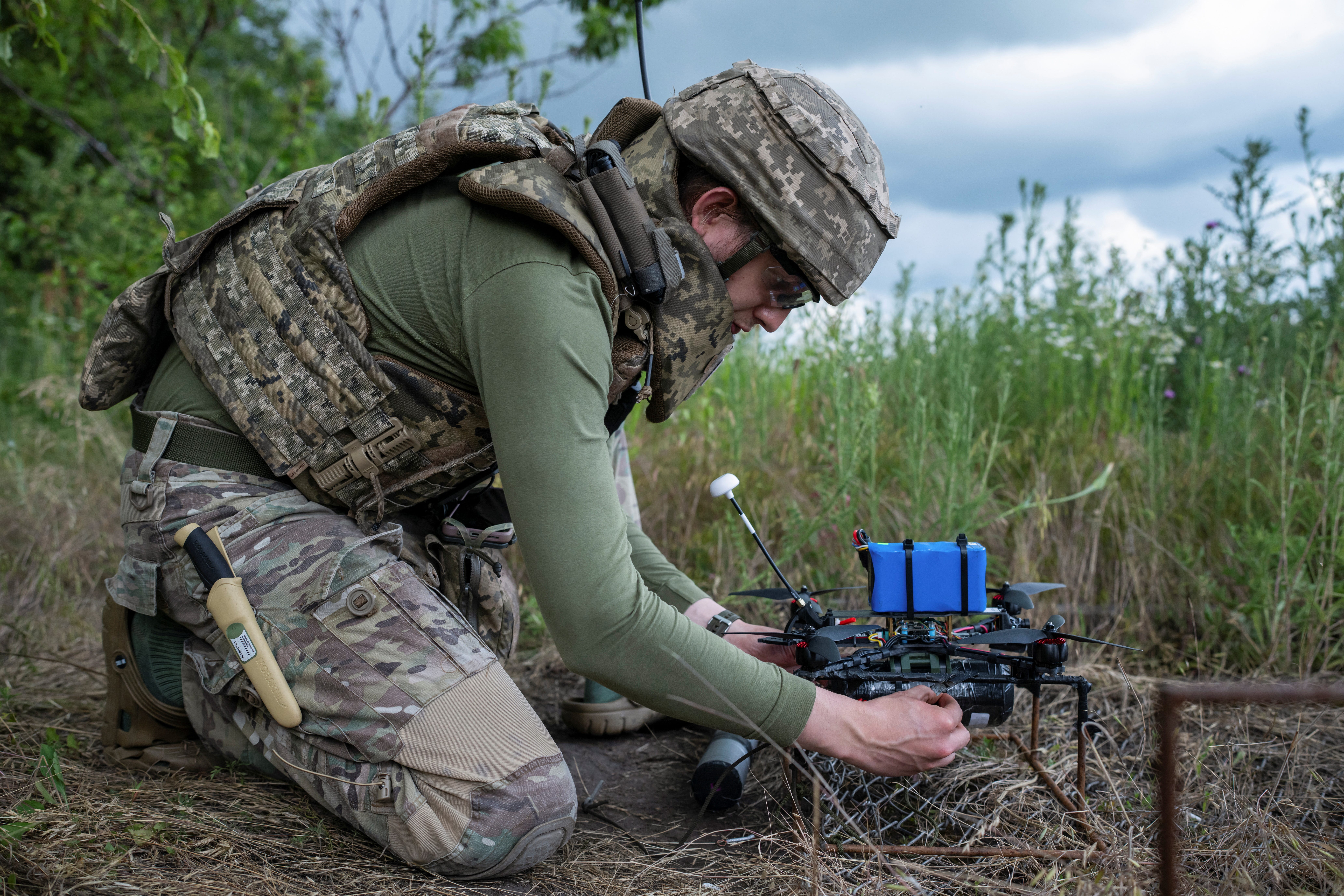 A service member of the 429th Achilles Separate Unmanned Aerial Systems Regiment prepares an FPV drone for a fly at a position near the front line town of Kupiansk, amid Russia's attack on Ukraine, in Kharkiv region, Ukraine June 23, 2025.