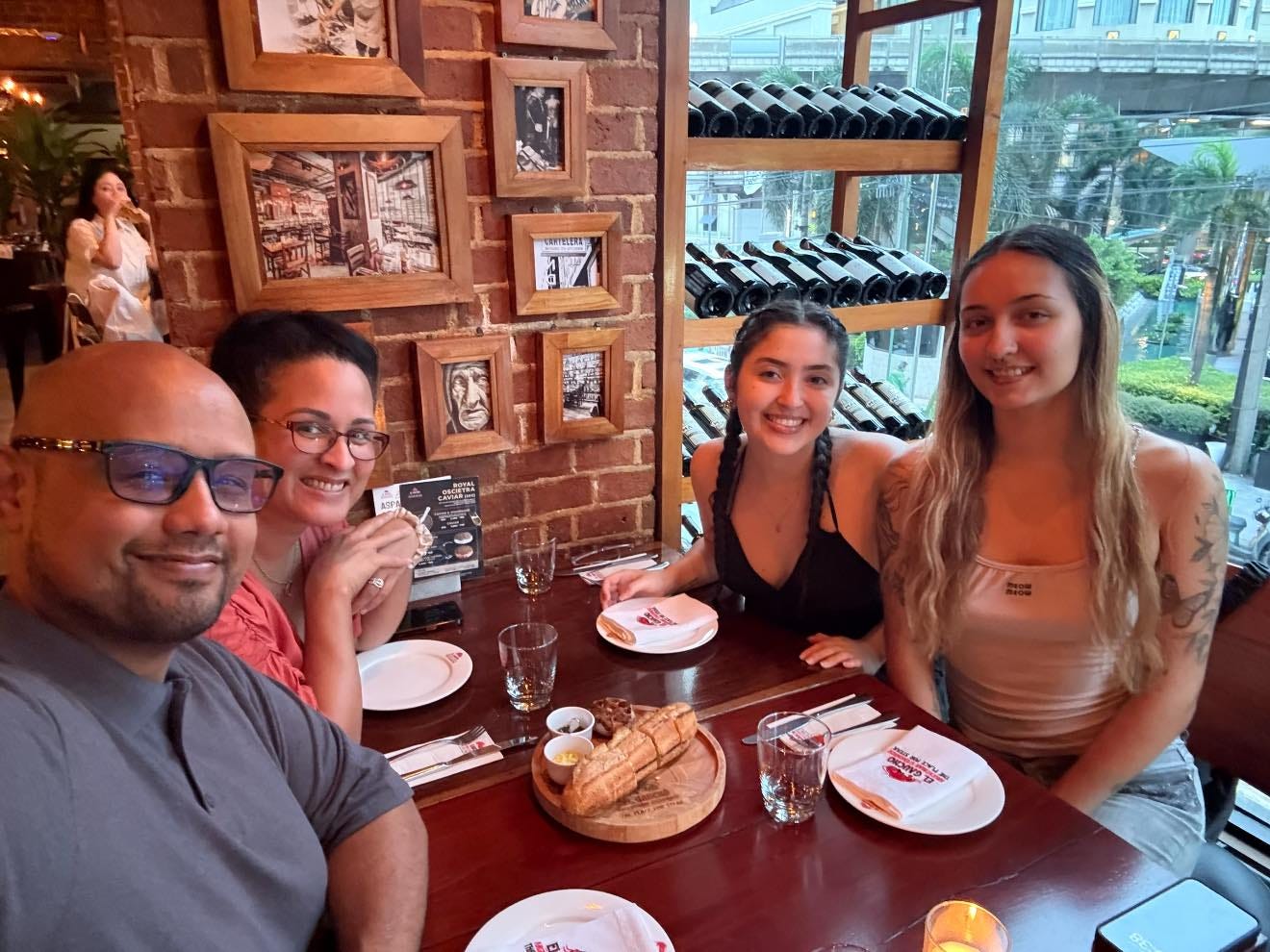 Kimanzi Constable family sitting at a table in a restaurant