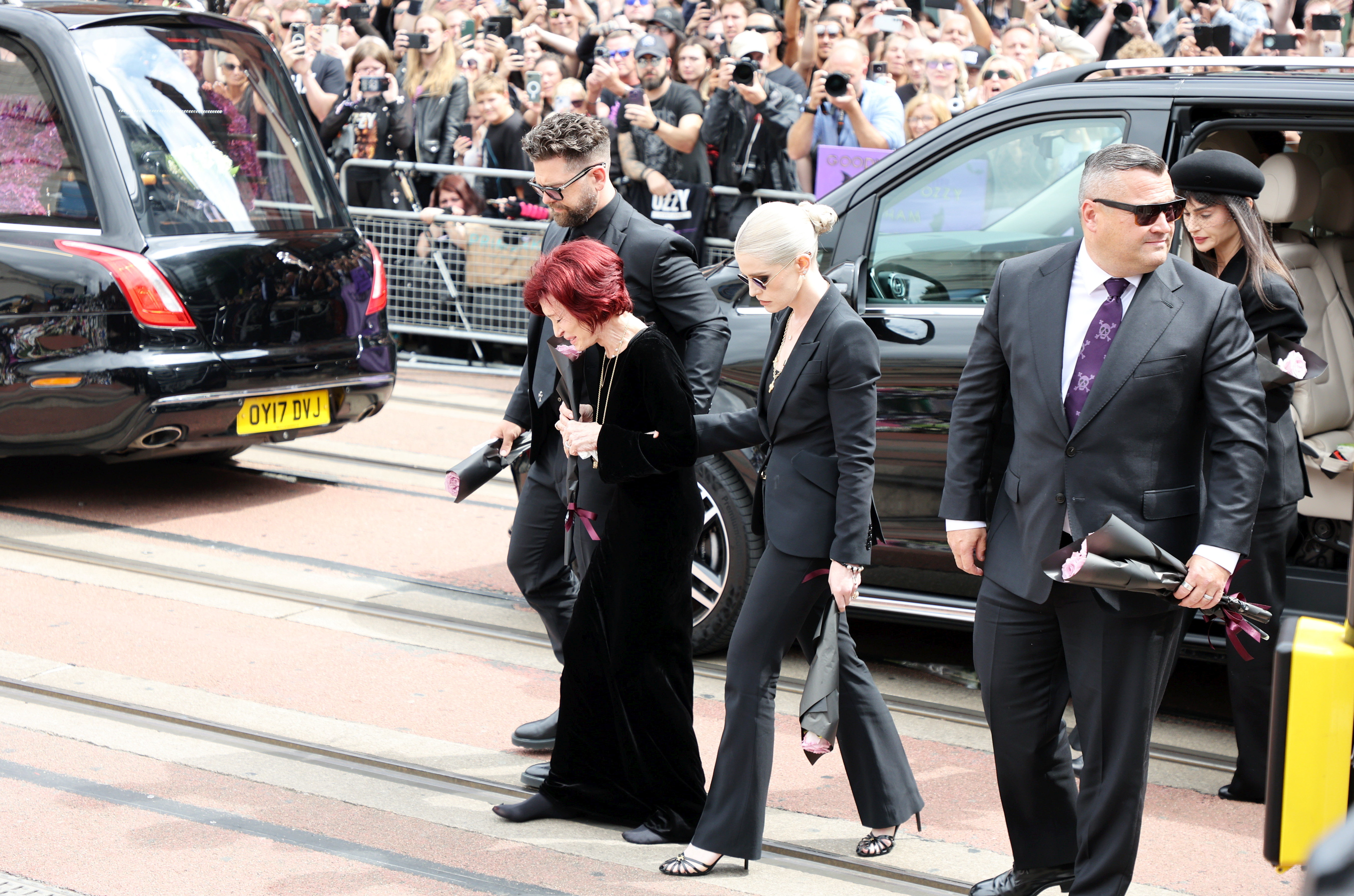 Jack Osbourne, Sharon Osbourne and Kelly Osbourne walking to view tributes to the late Ozzy Osbourne from fans