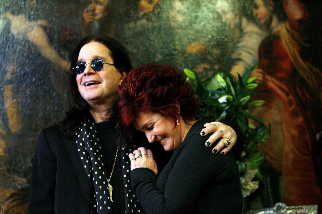 Ozzy and Sharon Osbourne smile as they pose in front of some of their belongings to be auctioned in Beverly Hills, California, November 26, 2007. 