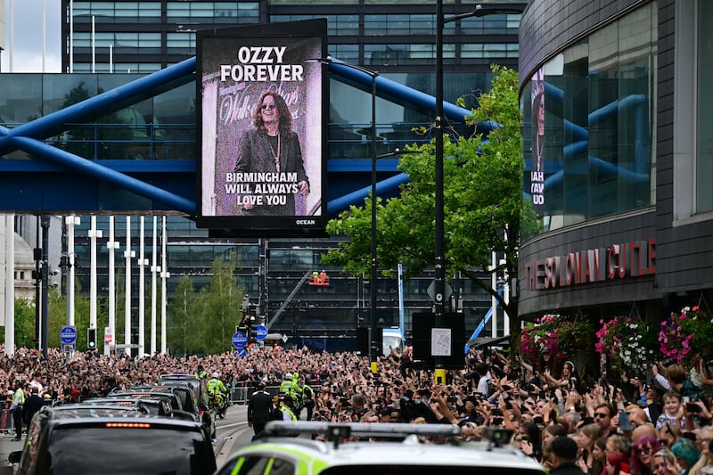 Mourners and music fans line the streets to pay their respects as the funeral cortege of Ozzy Osbourne, the late lead singer of Black Sabbath, makes its way through Birmingham, central England on July 30, 2025. Thousands are expected to line the streets in Ozzy Osbourne's UK hometown of Birmingham on Wednesday to honour the heavy metal hell-raiser Ozzy Osbourne as he is laid to rest. Osbourne, nicknamed the