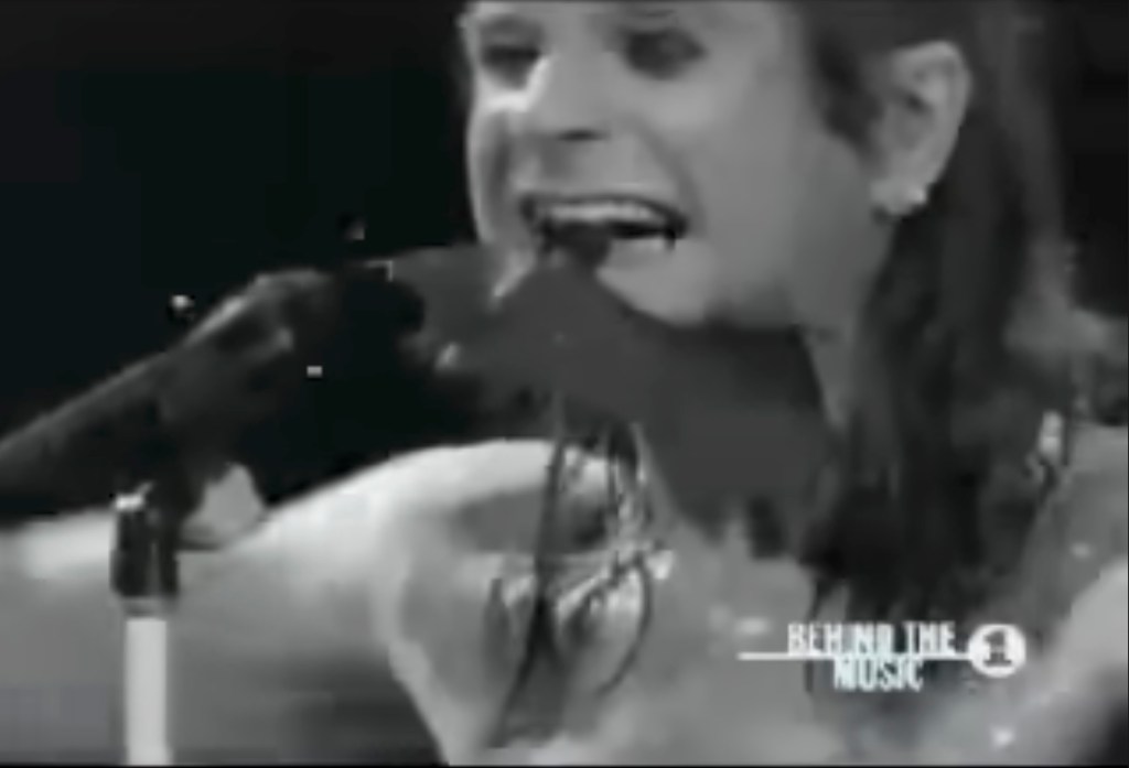 Ozzy Osbourne biting a head off a bat