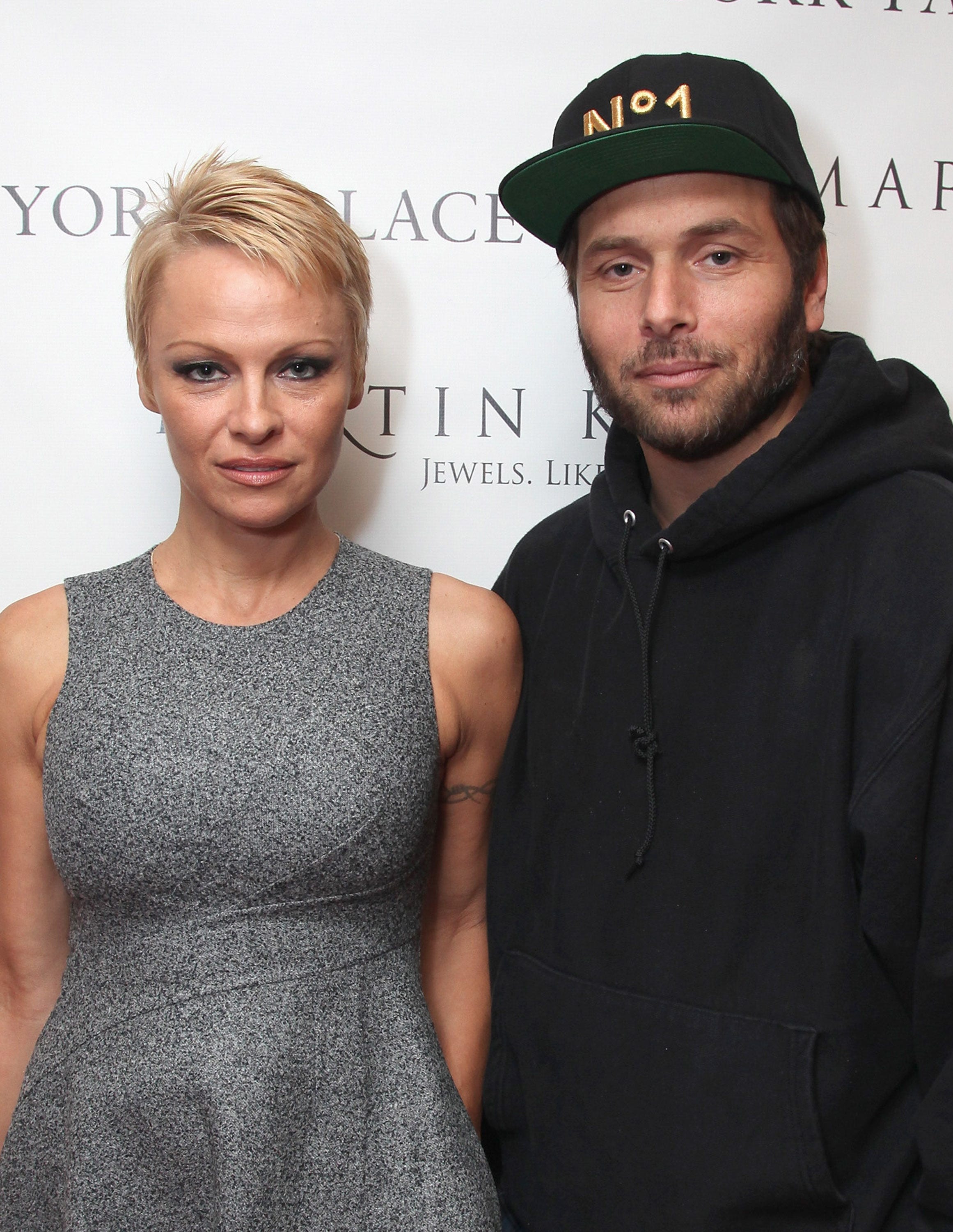 Pamela Anderson in a grey dress Rick Salomon in a black hoodie and hat
