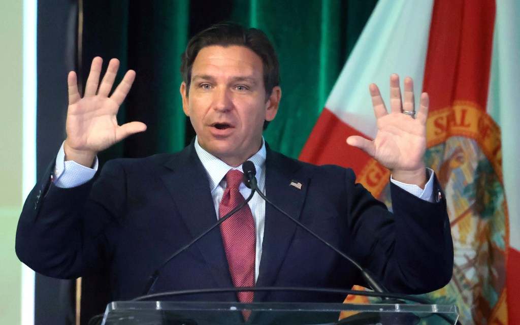 Ron DeSantis speaking at a podium.