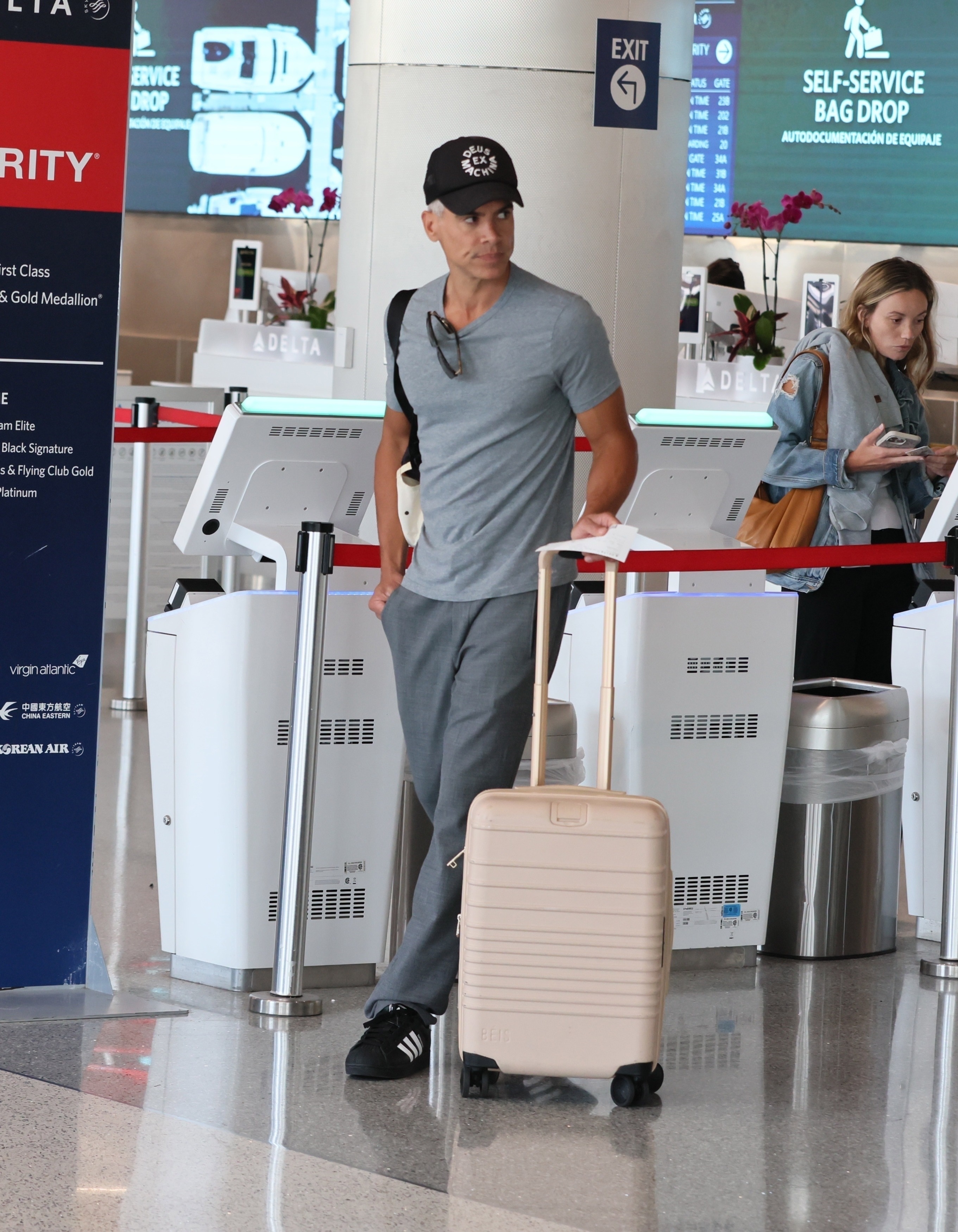 Cash Warren pushes a suitcase at LAX. 