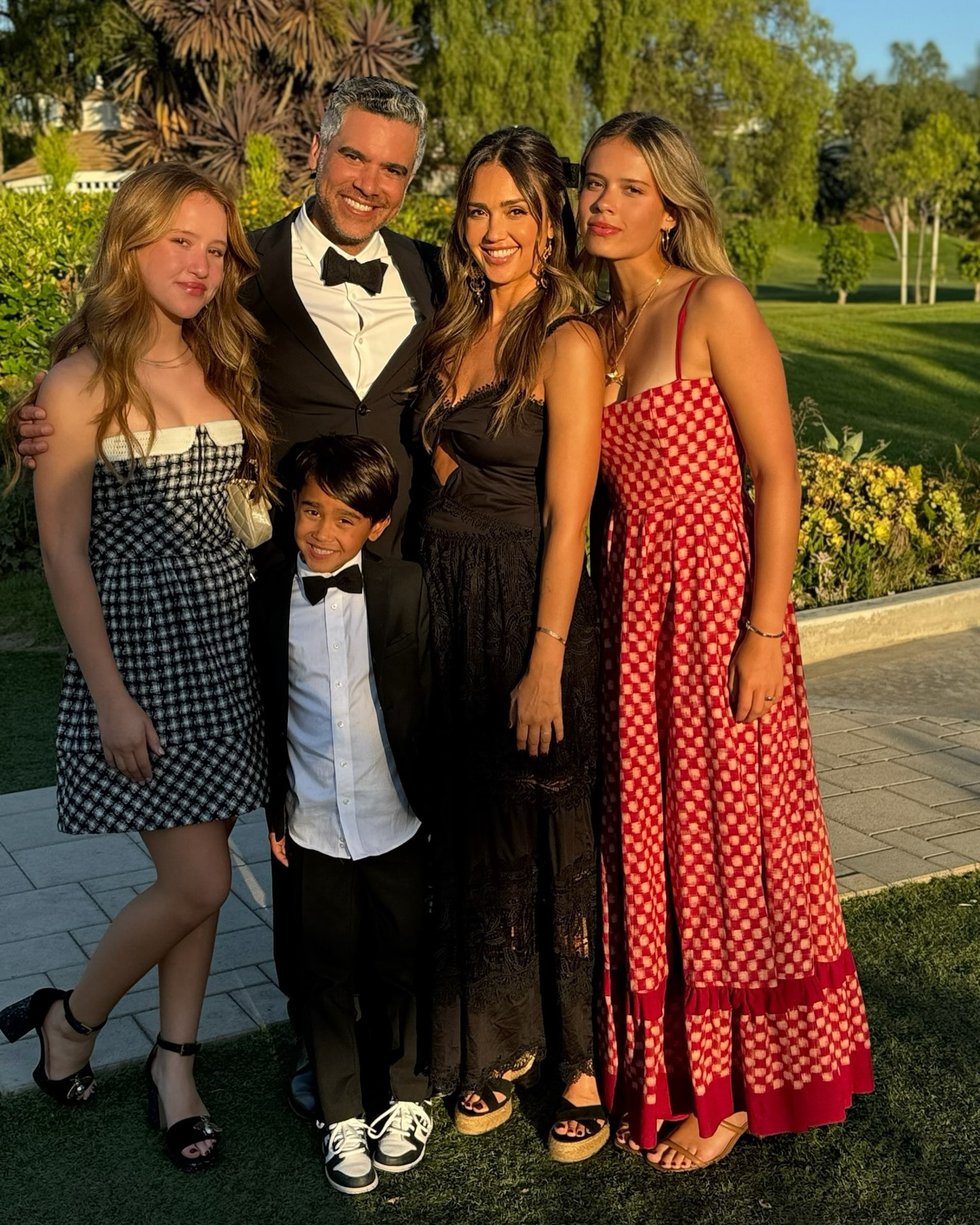 Jessica Alba, Cash Warren, and their kids outdoors. 