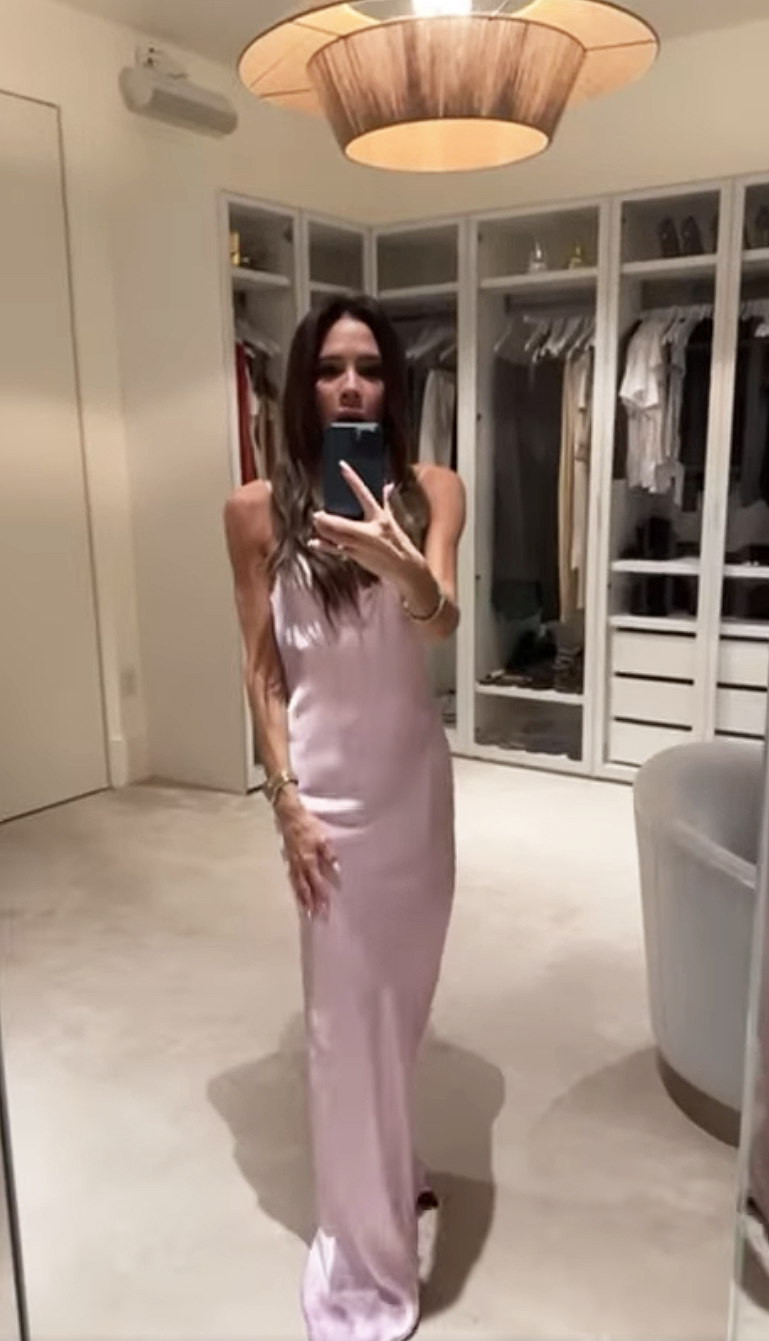 Victoria Beckham poses in a pink dress.