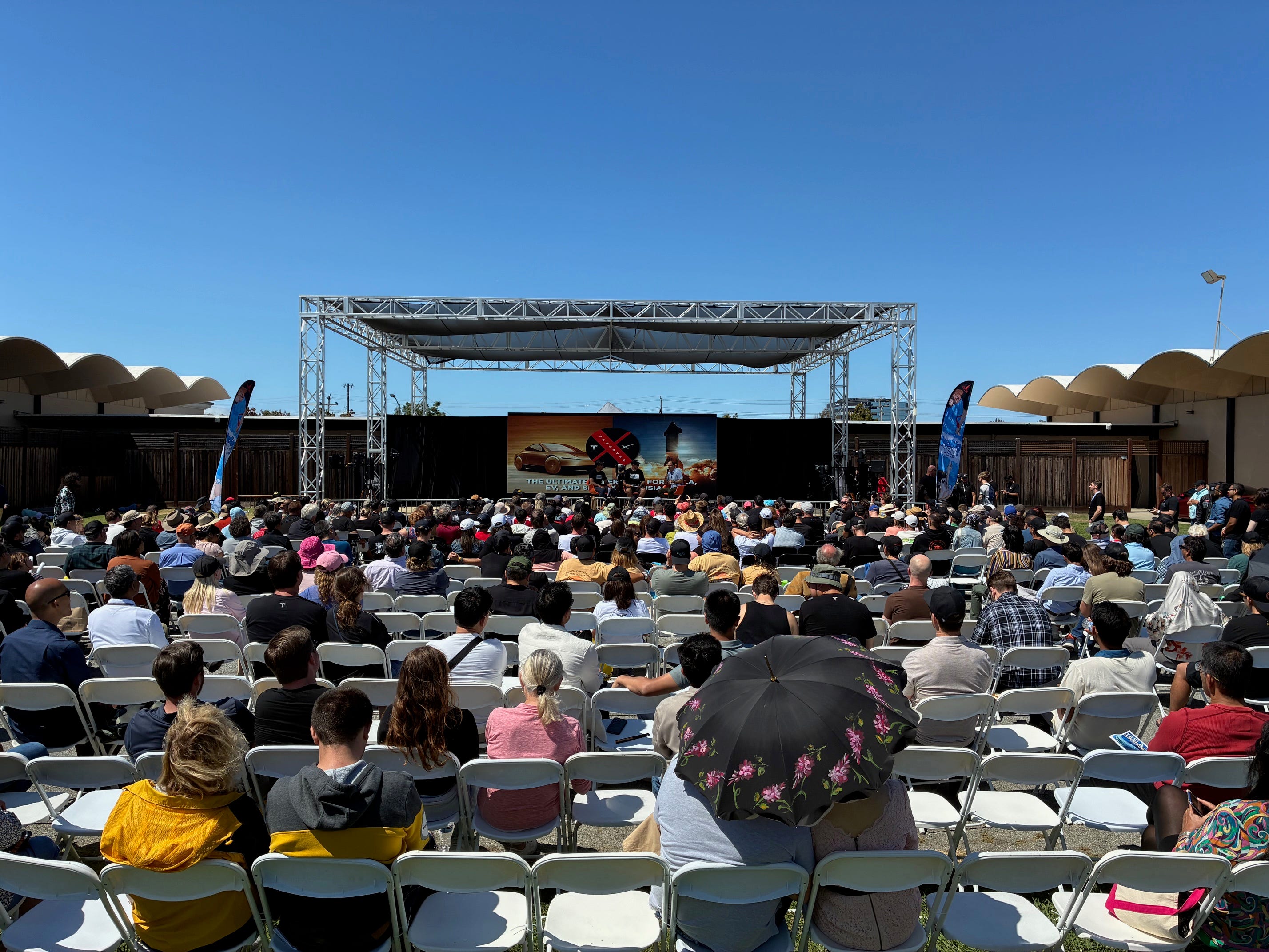 Attendees watch Tesla VP of Vehicle Engineering Lars Moravy speak on stage at the X Takeover event in Silicon Valley