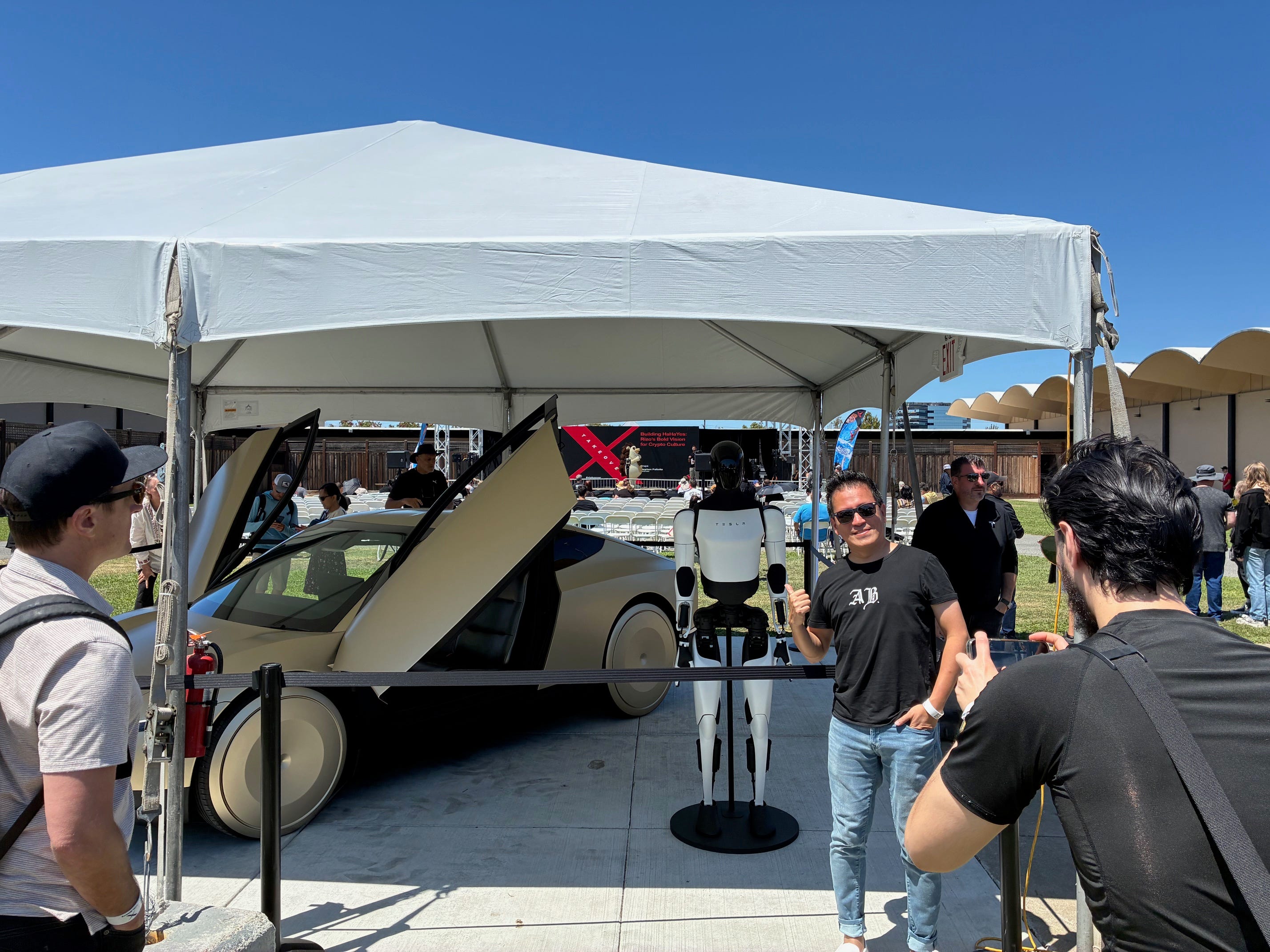 A Tesla fan has a photo taken at an X Takeover event in Silicon Valley