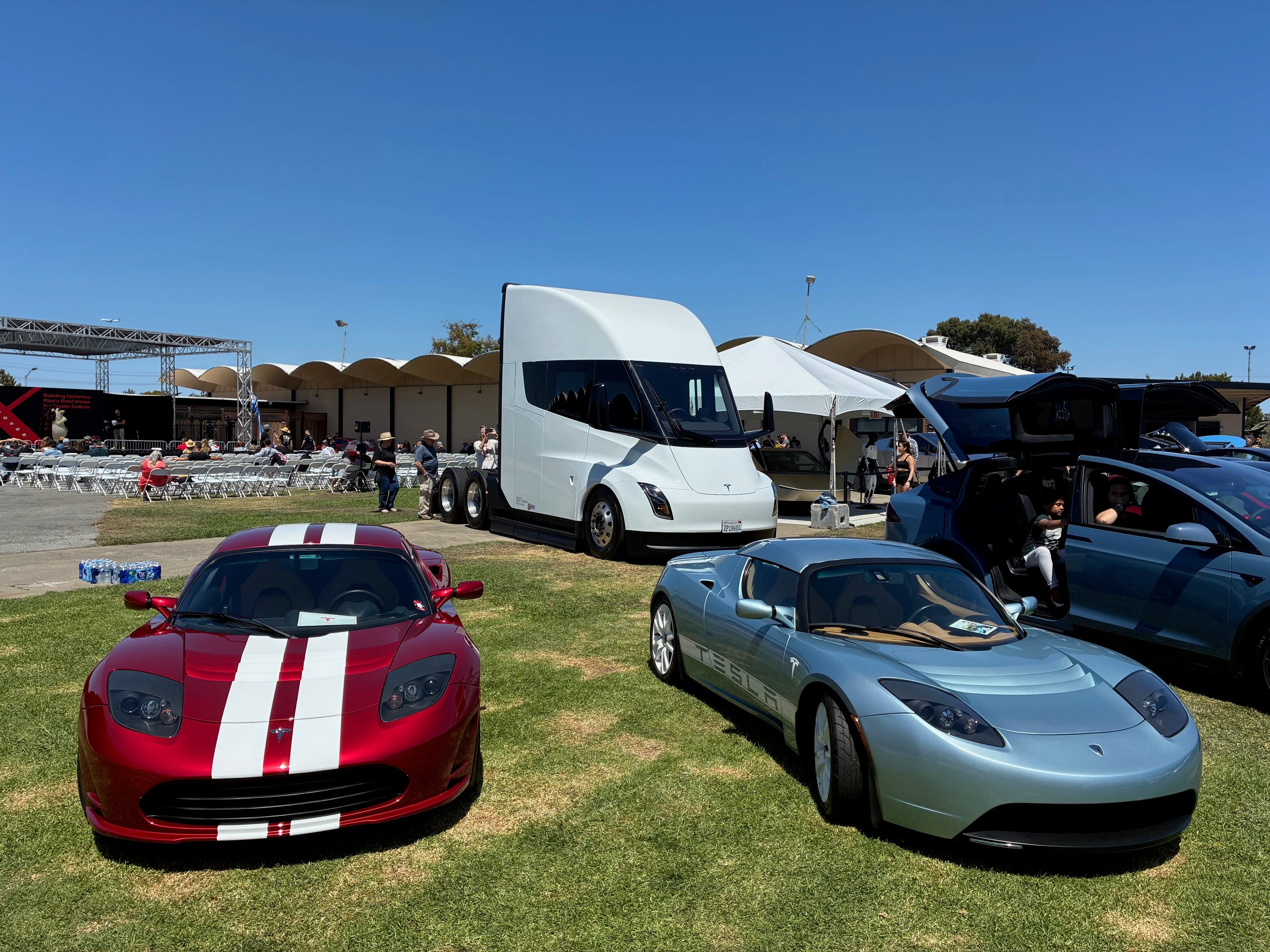 Original Tesla Roadsters parked near a Tesla Semi truck at an X Takeover event in Silicon Valley