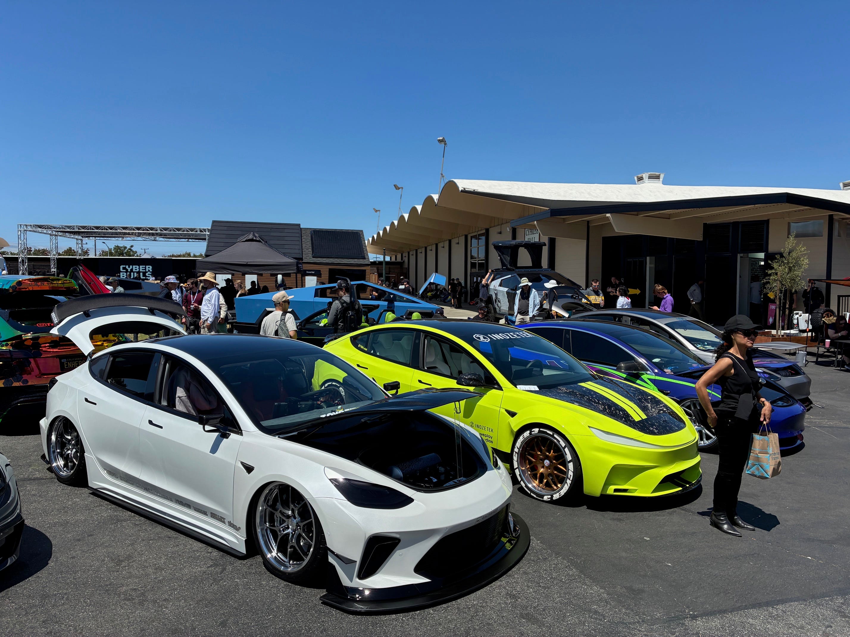 Modified Tesla Model 3 vehicles at an X Takeover event in Silicon Valley