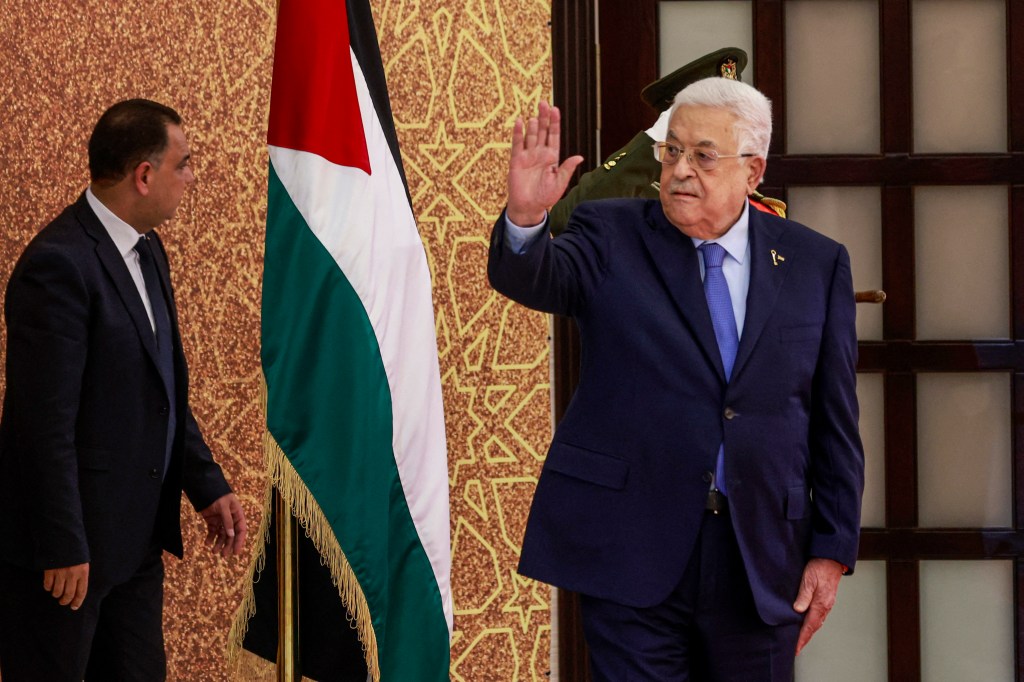 Palestinian Authority President Mahmud Abbas waves during a swearing in ceremony of mewly-appointed ministers, on March 31, 2024, in Ramallah, in the occupied West Bank.