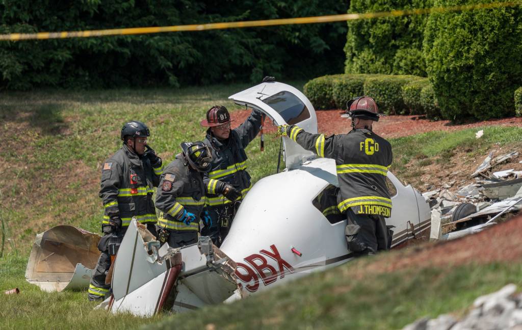 Firefighters attending to a small plane crash.