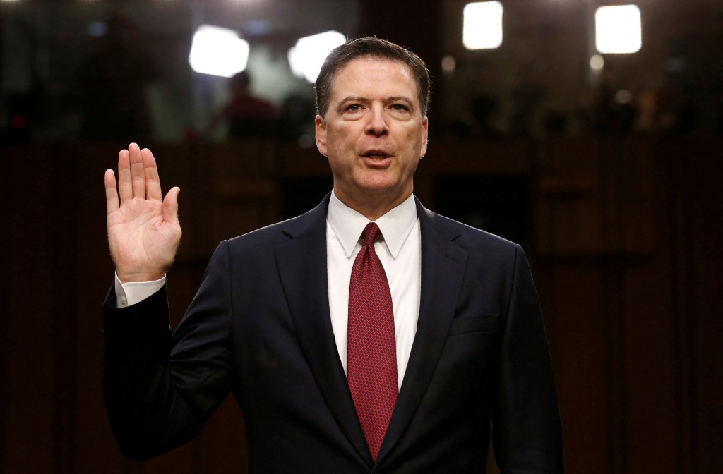 James Comey being sworn in at a hearing.