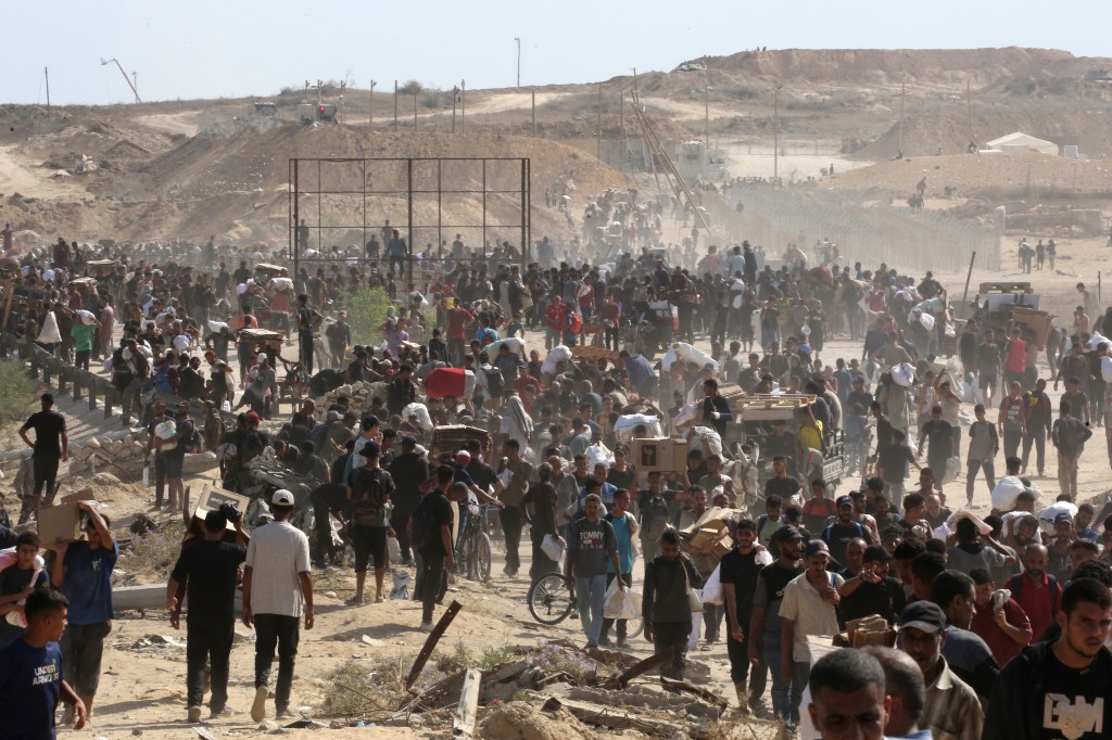 Displaced Palestinians receiving aid in Gaza.