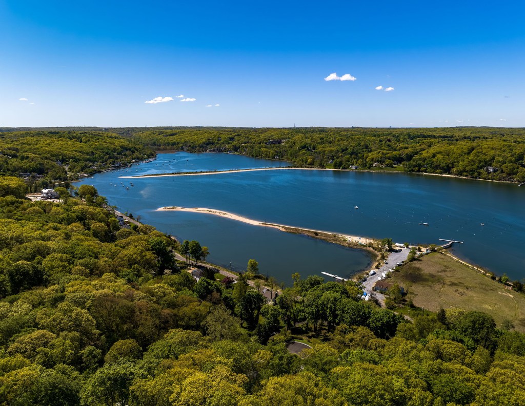 Aerial view of Oyster Bay, Long Island, showing a large sandbar and boats.