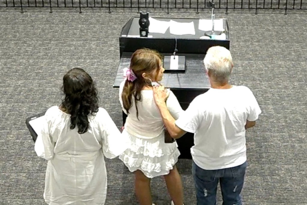 Three people at a table; two women and a man.