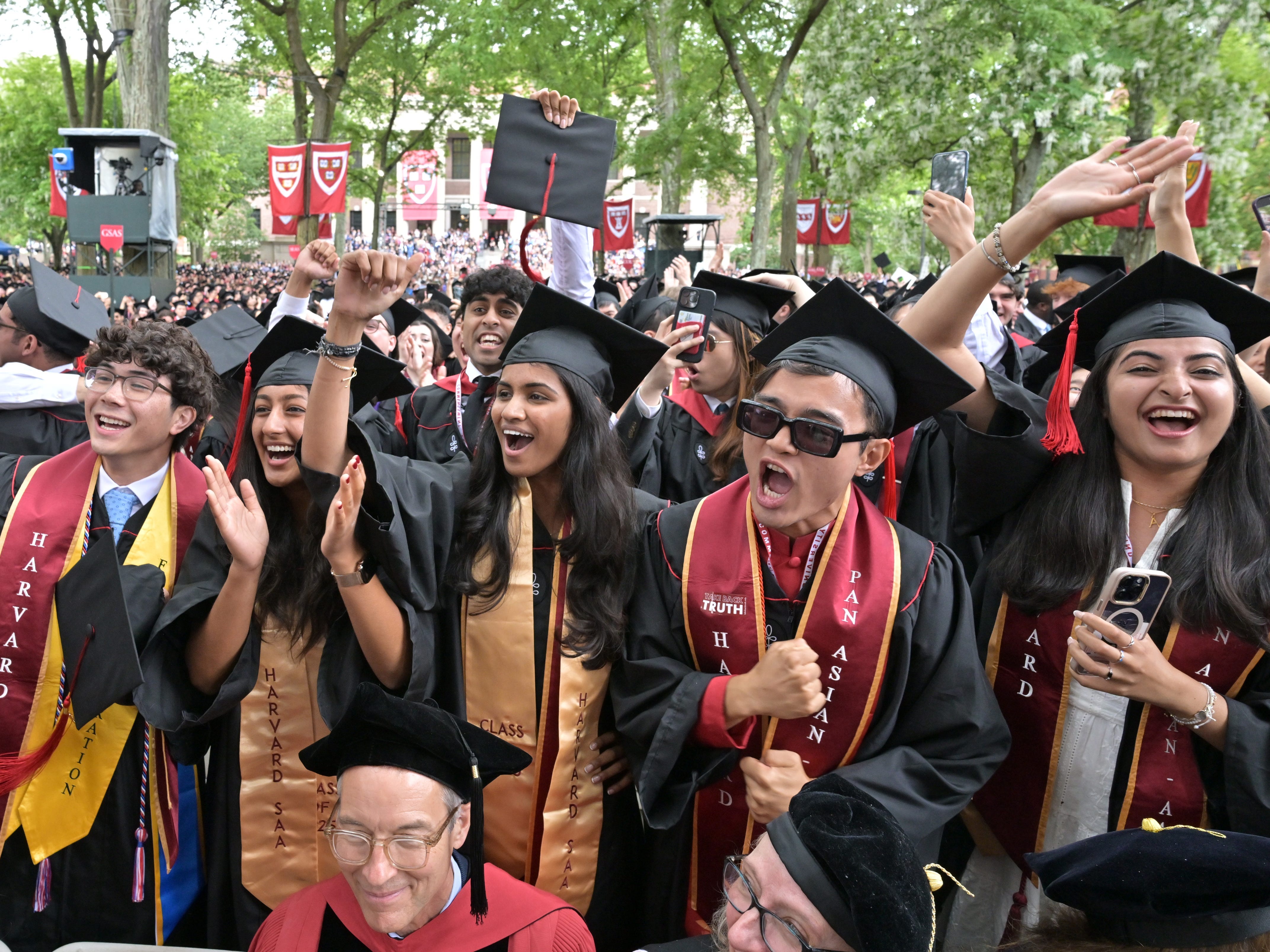 Students at Harvard University's commencement, wearing graduation caps and gowns
