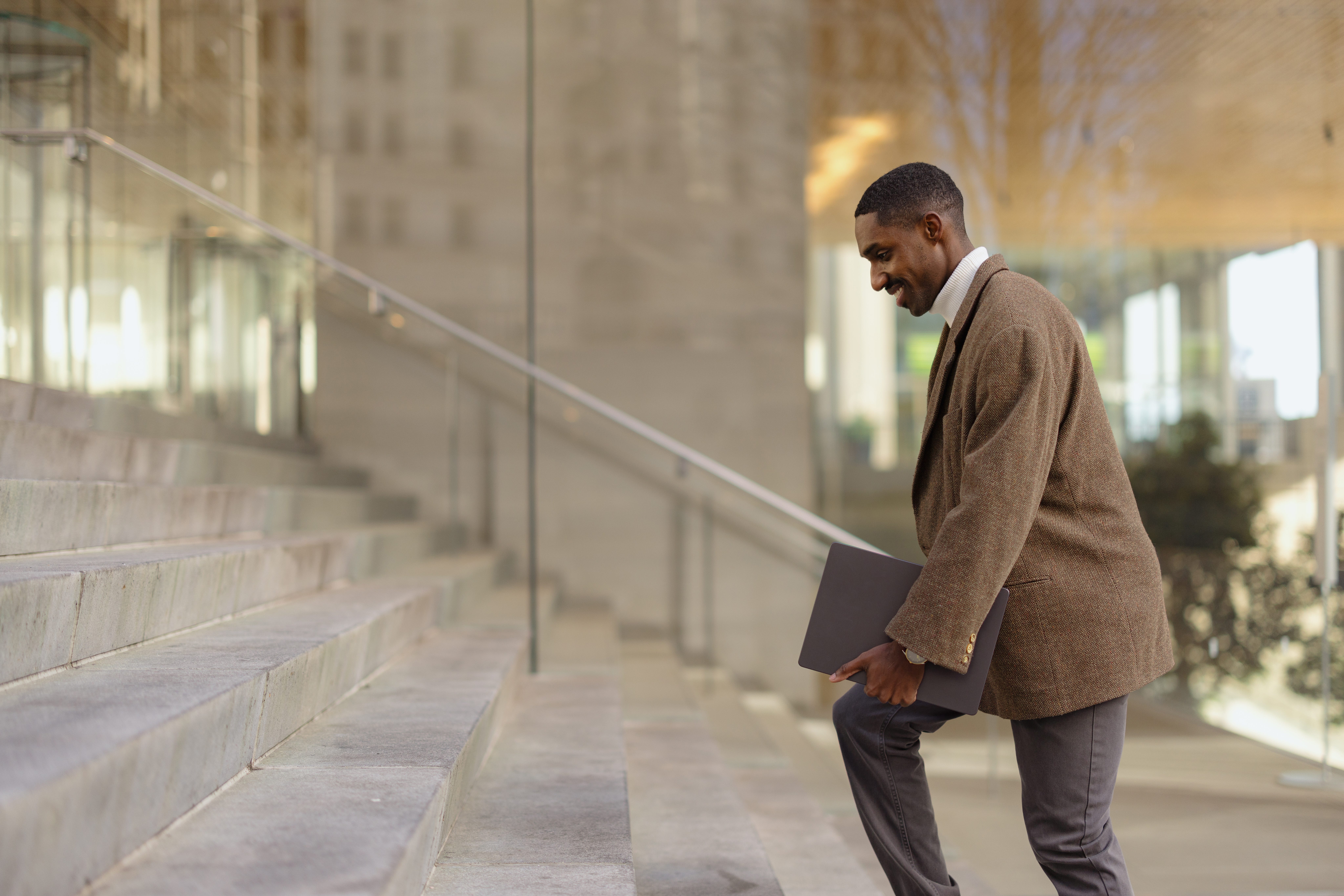 Man in suit climbing stairs