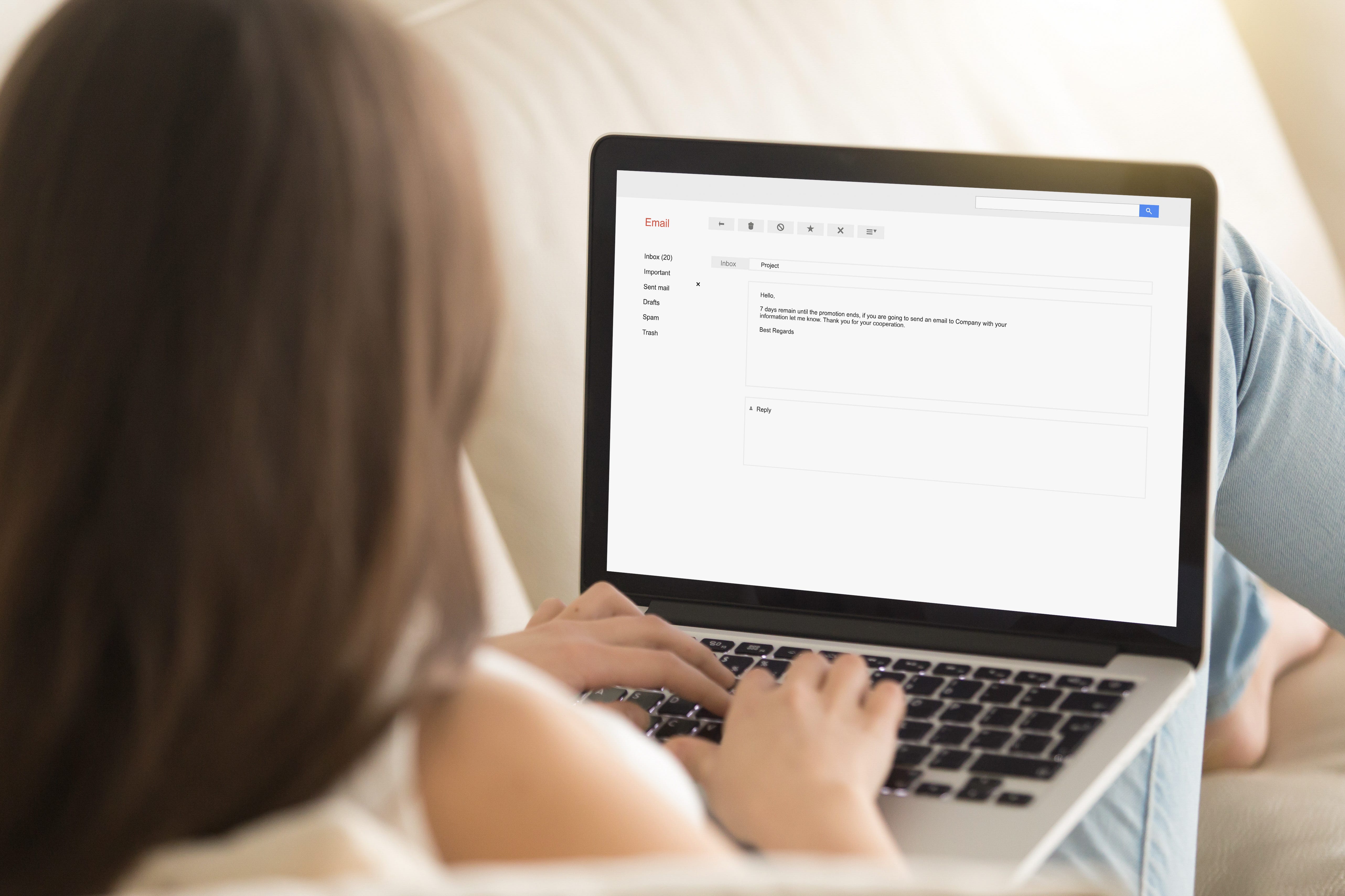 Woman typing an electronic message on a laptop.
