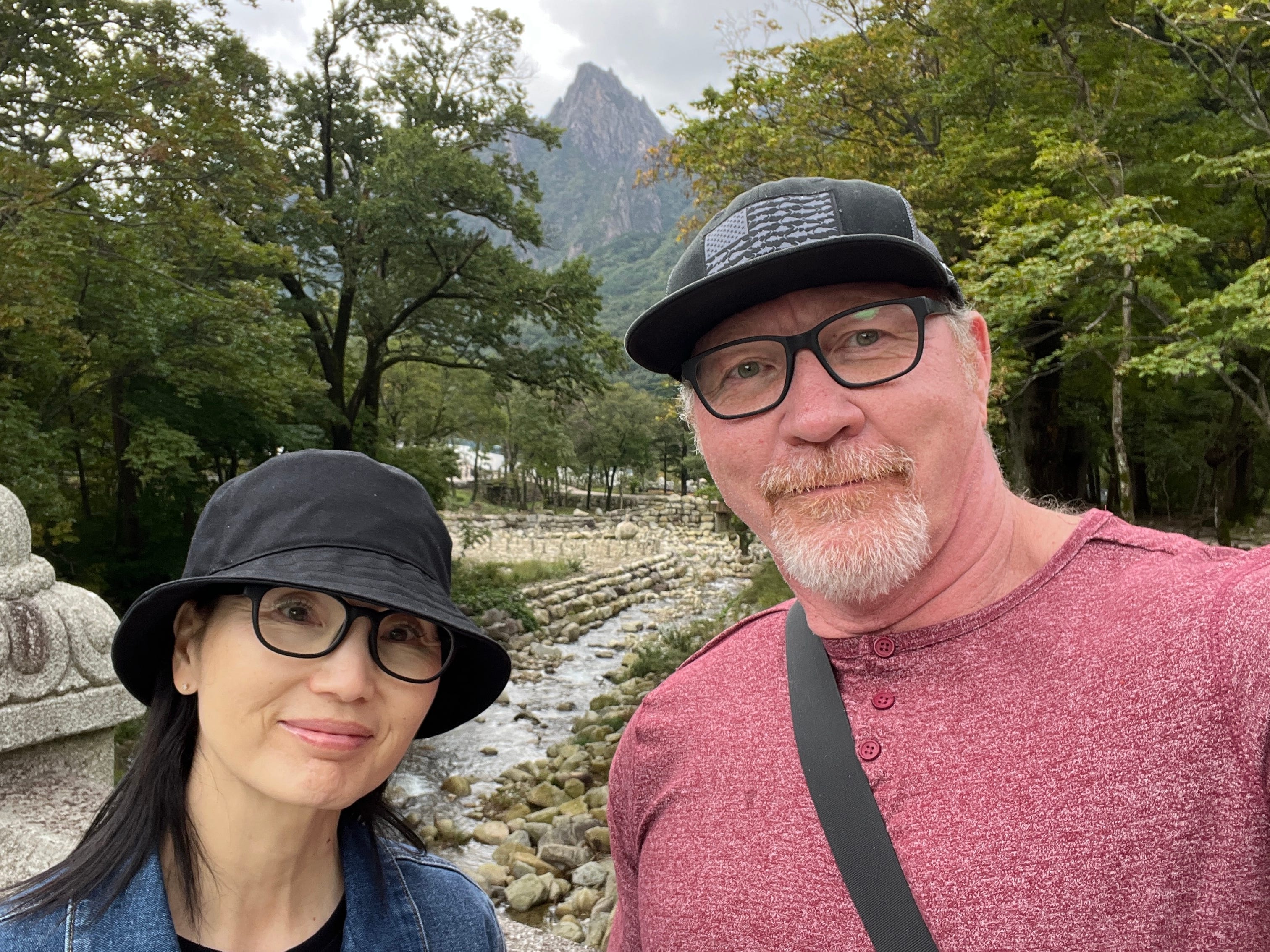 A couple taking a selfie on a hike.
