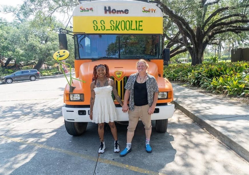 Scott Heltz and his partner, Shaquita Riley, outside their renovated school bus.