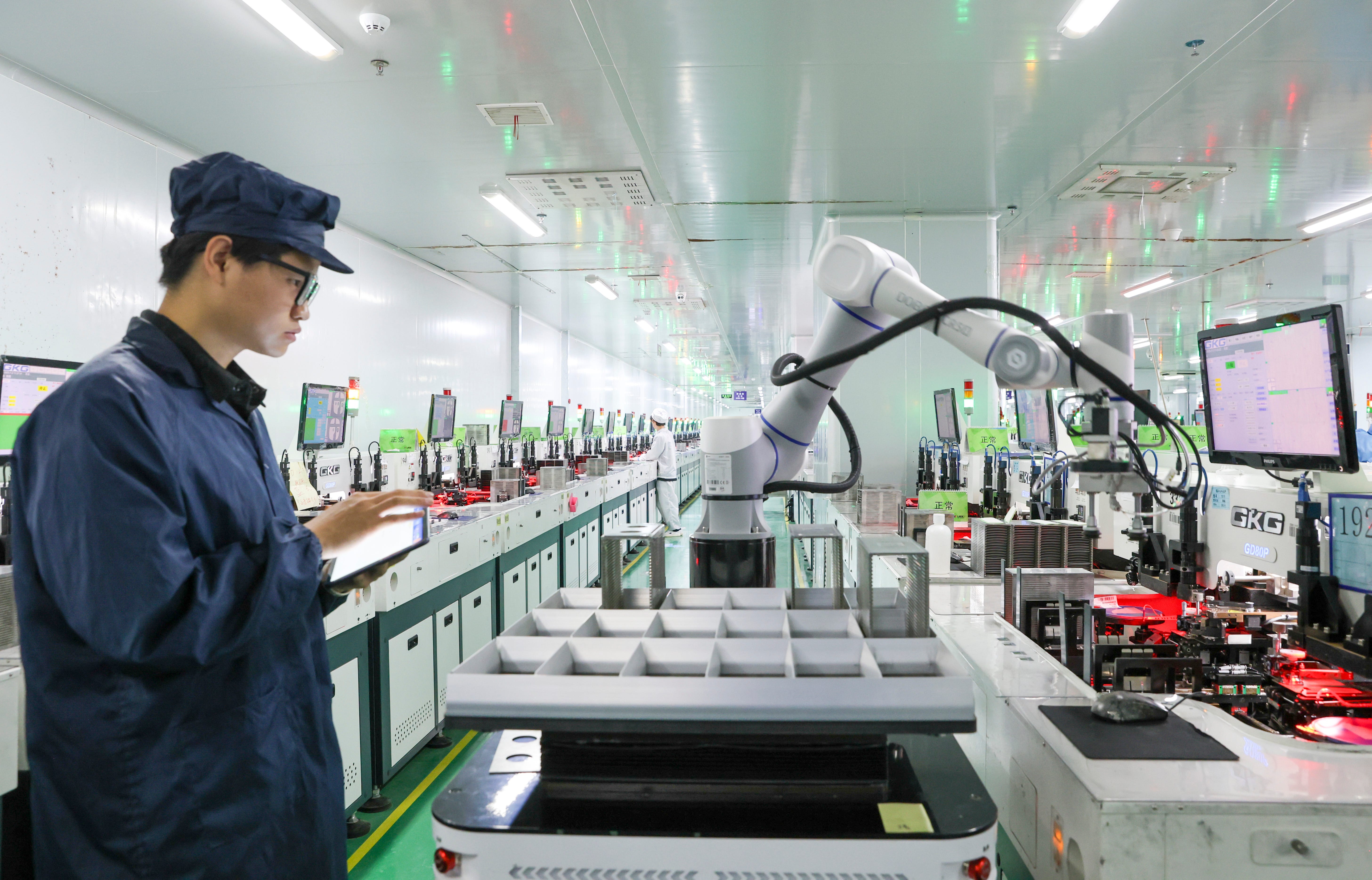 An employee operates robotic equipment at the factory of Jiangxi Lanke Semiconductor Co., Ltd, in Jiujiang, Jiangxi Province of China, on July 2, 2025.