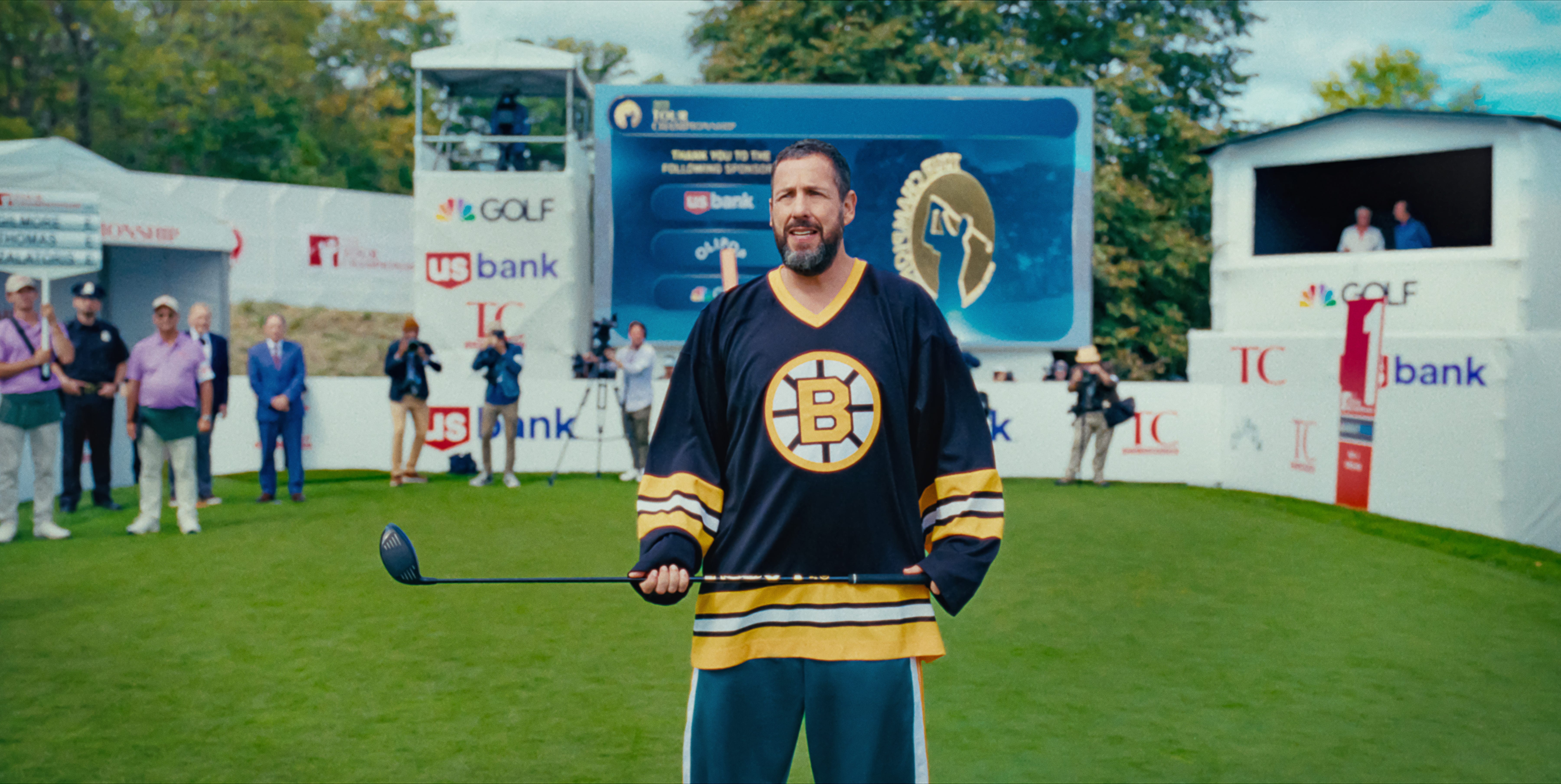 Adam Sandler holding a golf club
