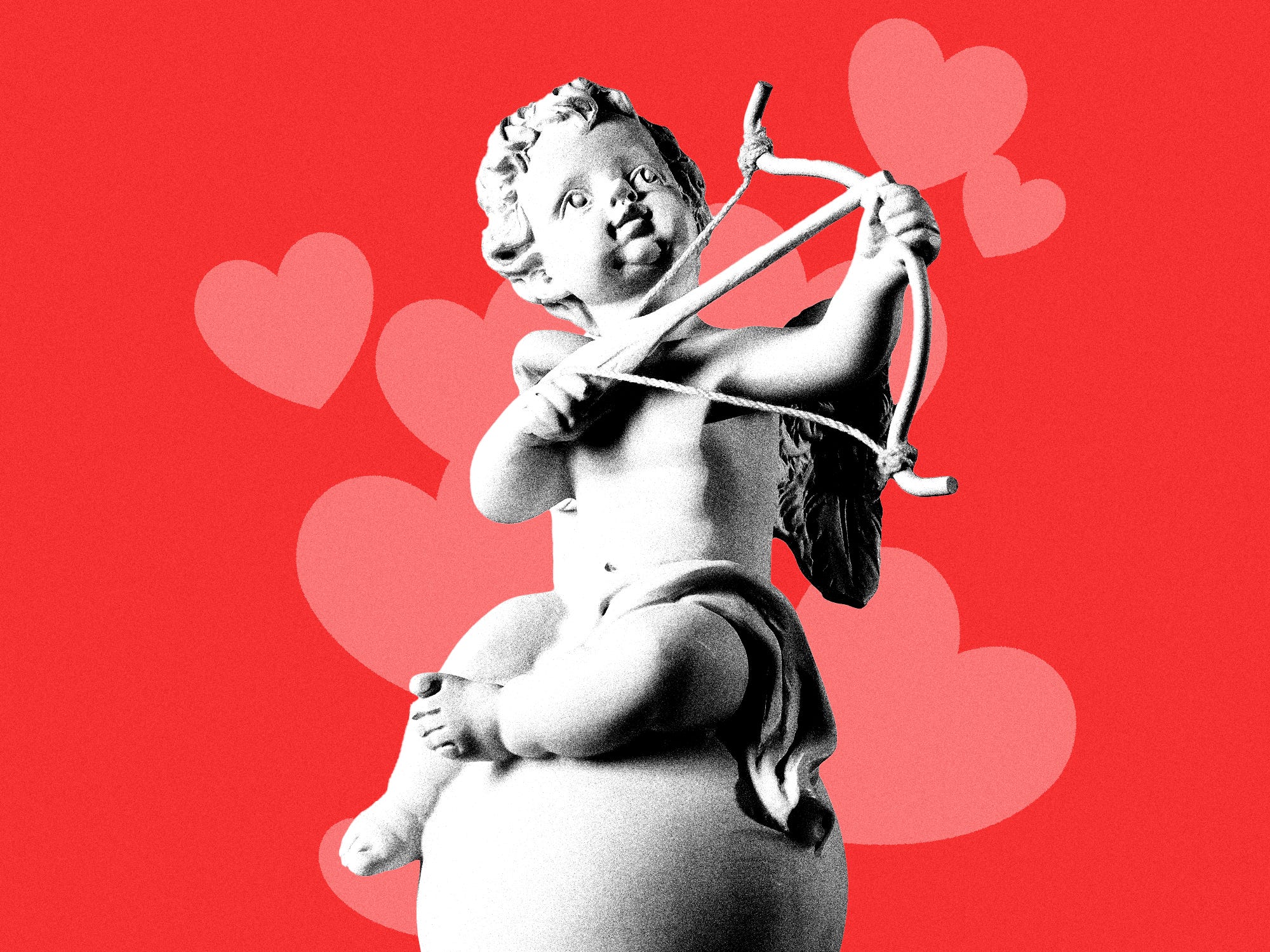 A statue of cupid surrounded by pink hearts