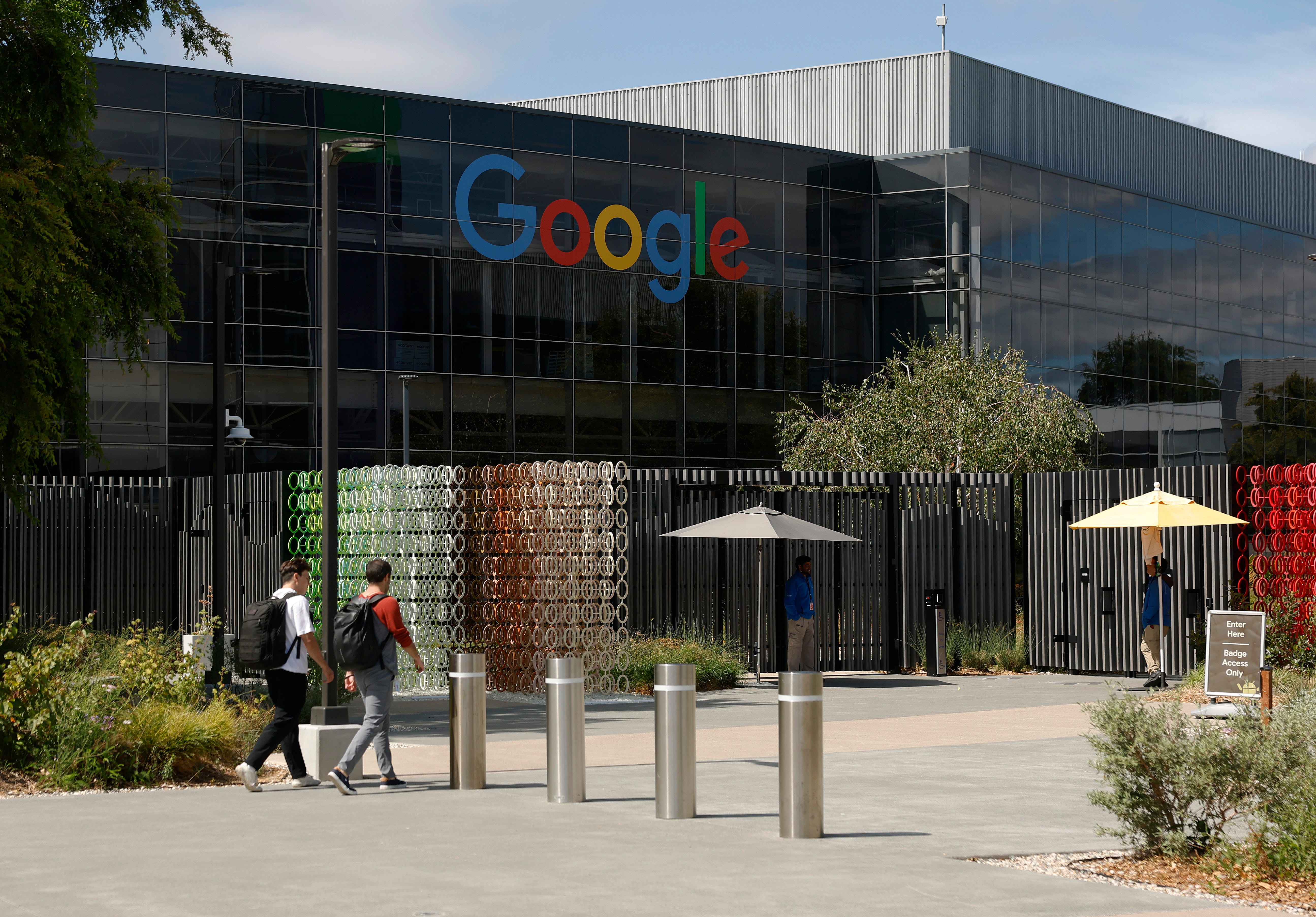 Employees walk into Google headquarters in California