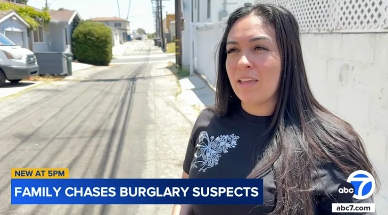 Woman interviewed on a residential street about a family chasing burglary suspects.