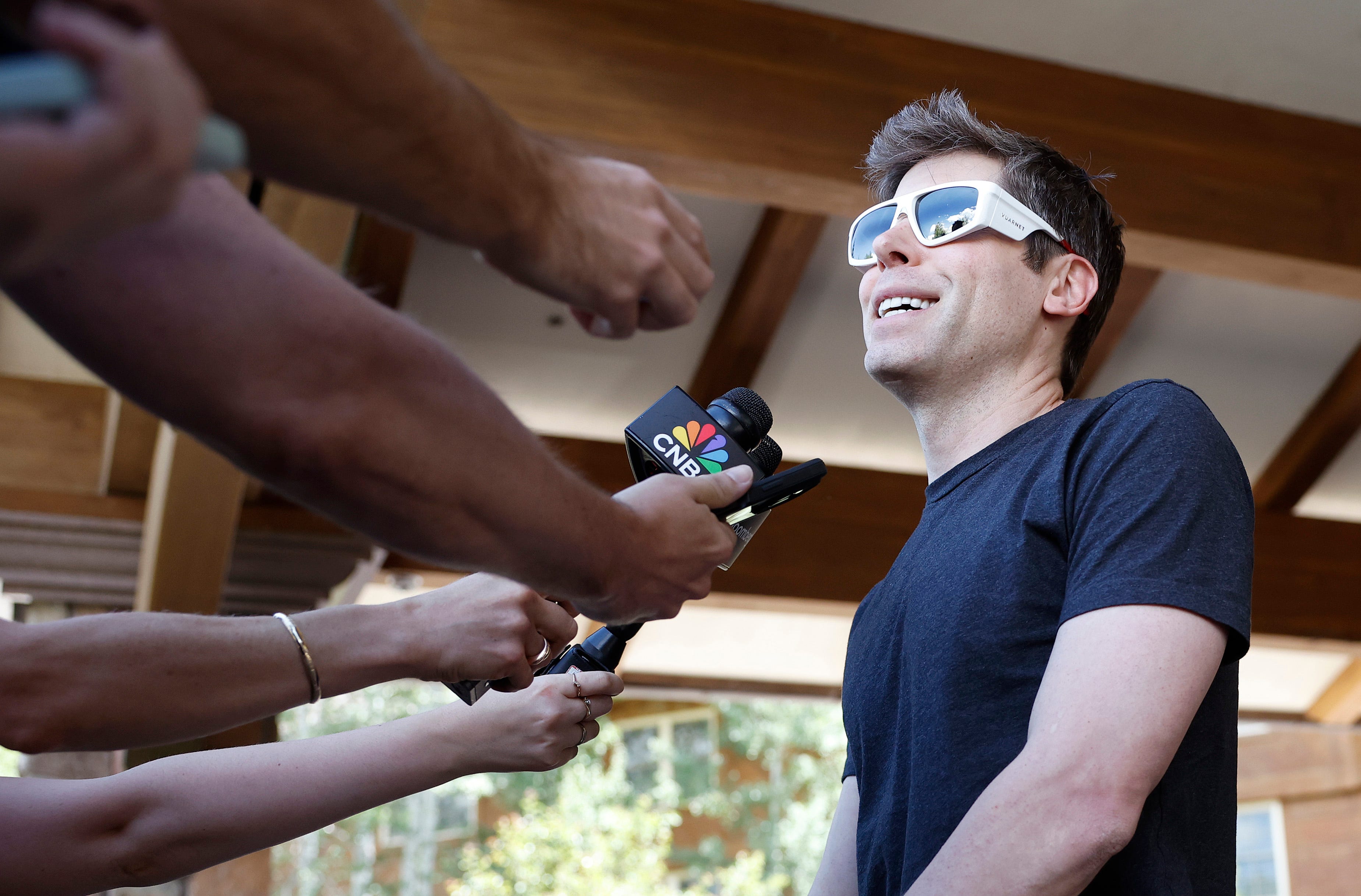 Sam Altman speaking into a mic