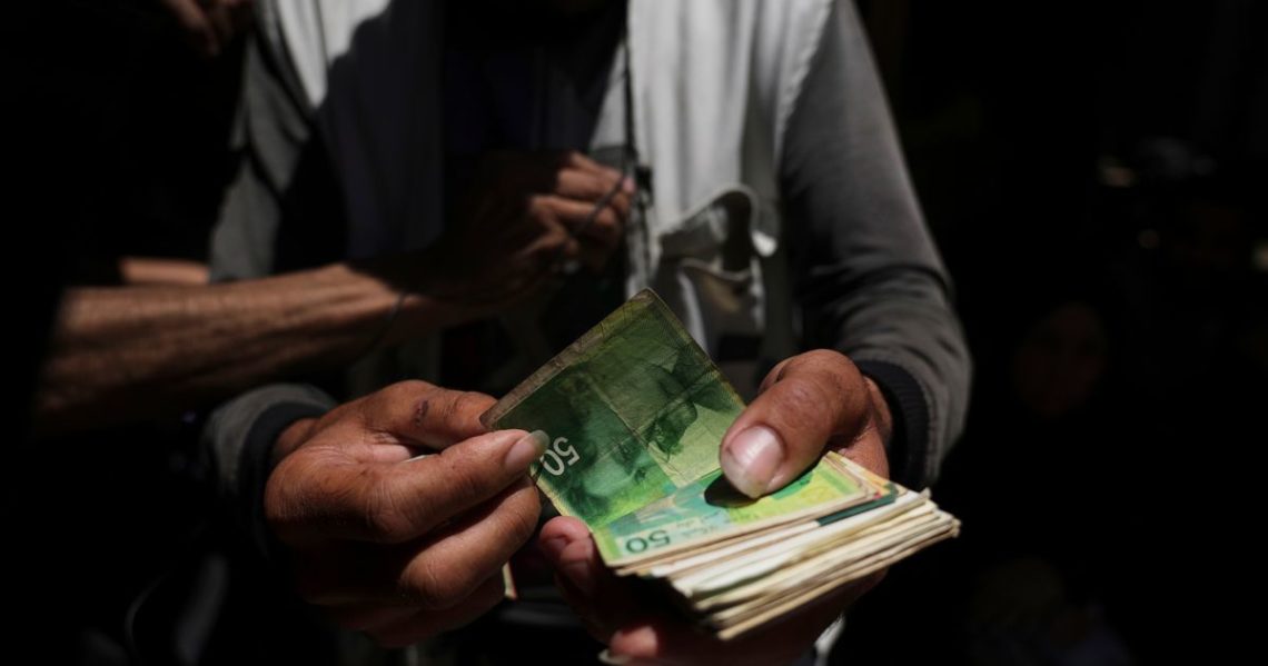 Cash is scarce in Gaza. Palestinians are paying a high price to get it